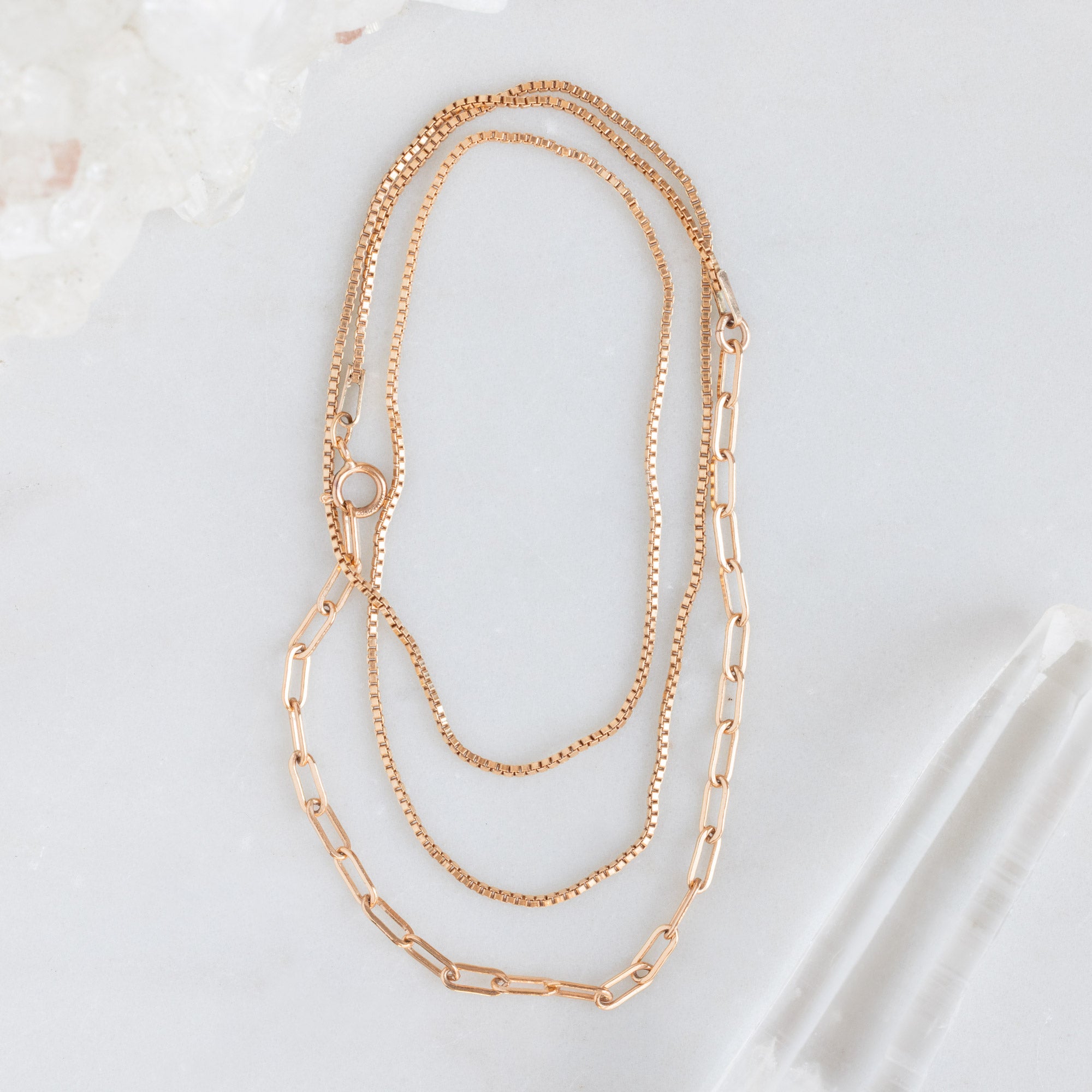 The 4-in-1 Cable Chain Bracelet in 14K Rose Gold on White Marble Surface