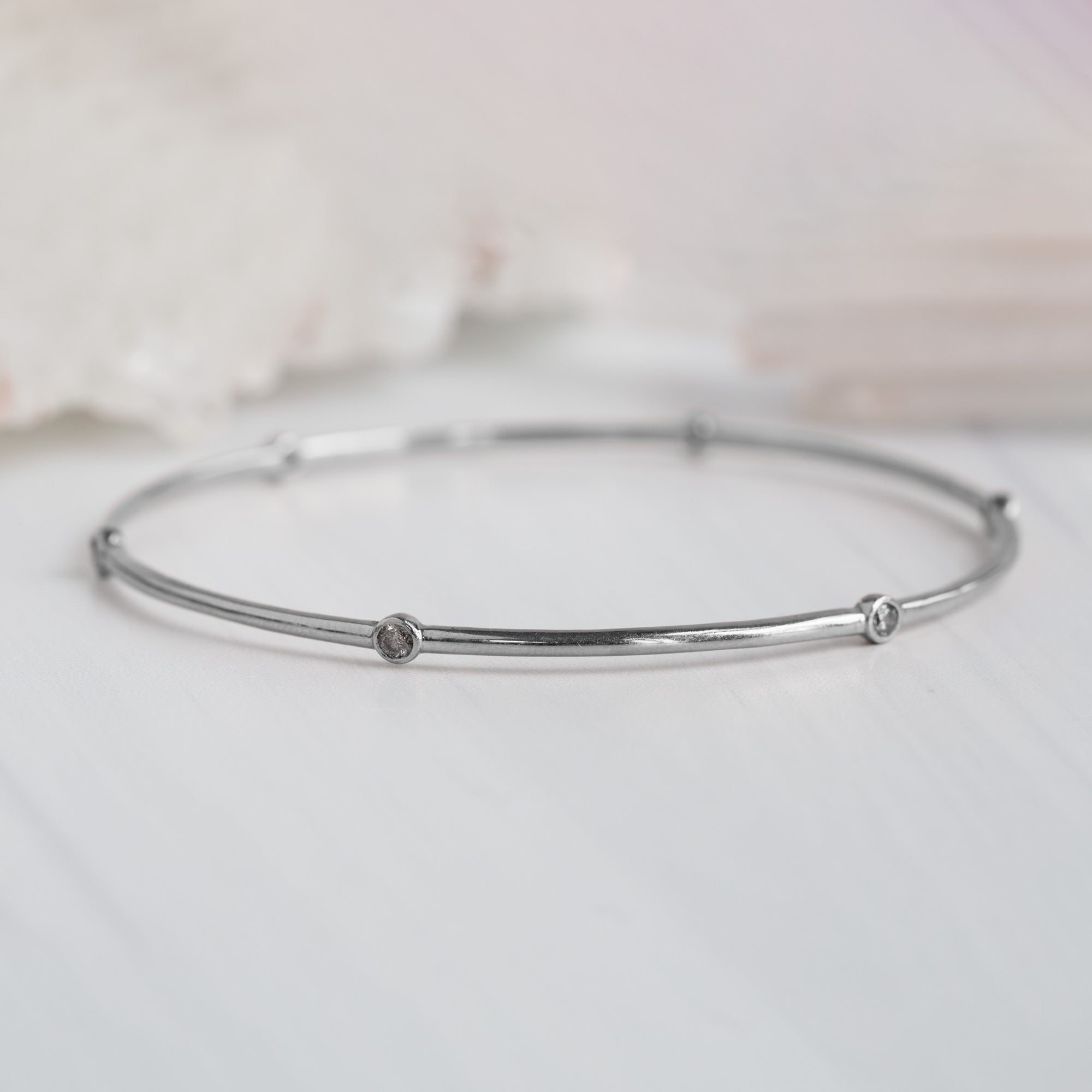 The Salt and Pepper Diamond Constellation Bangle in 14K White Gold on White Marble