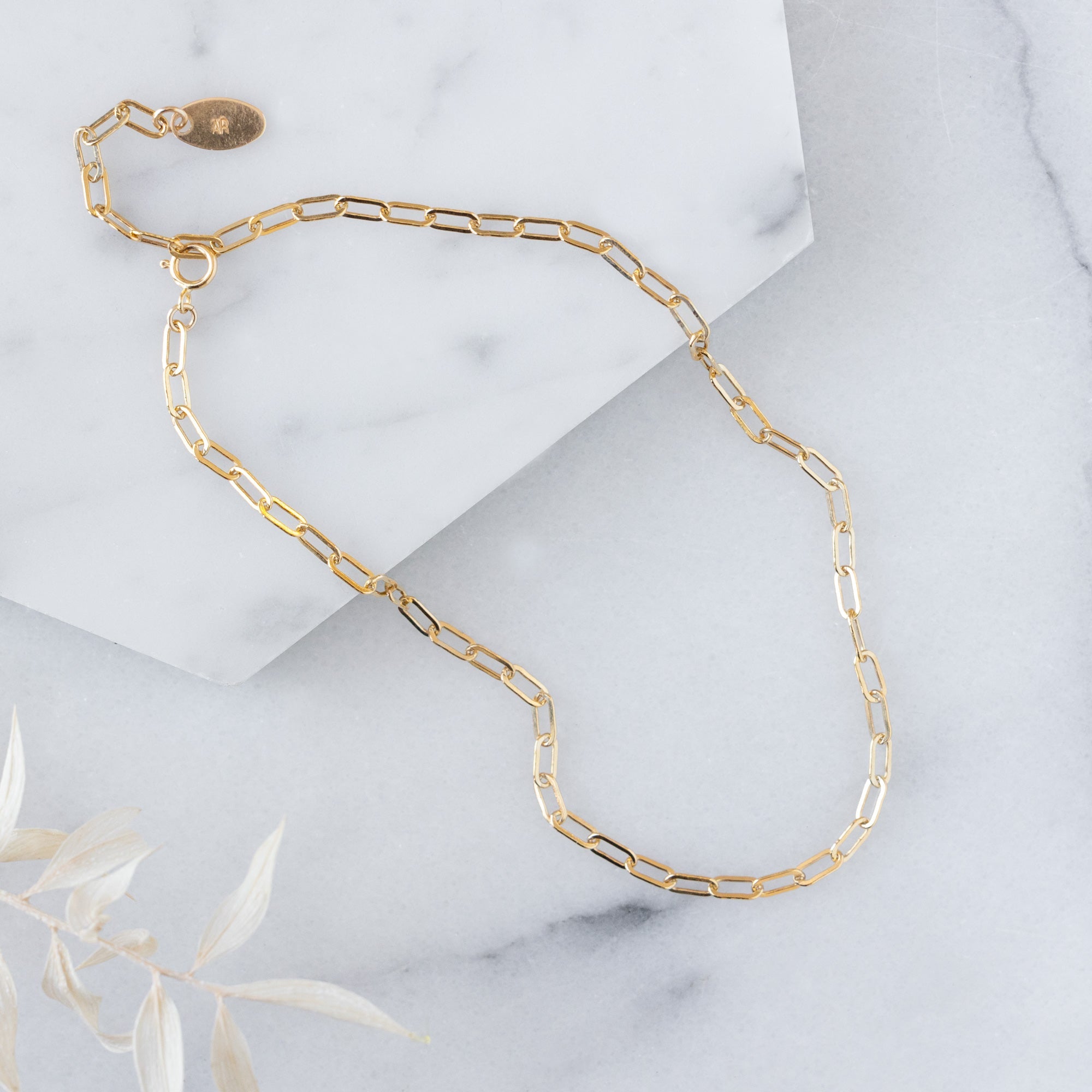 The Drawn Cable Chain Bracelet in Yellow Gold Filled on White Marble
