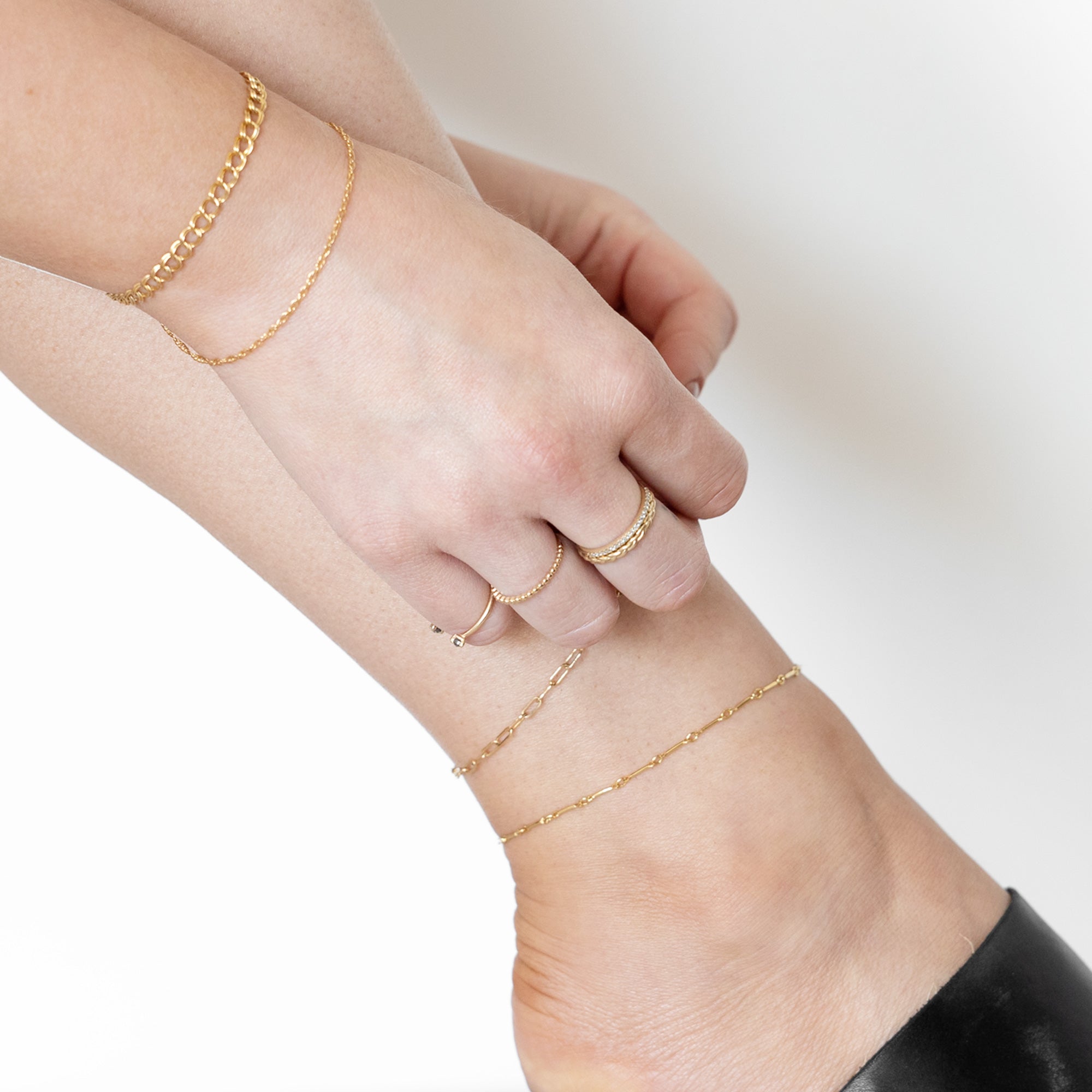 Model putting on The Bar Chain Anklet in Yellow Gold Filled