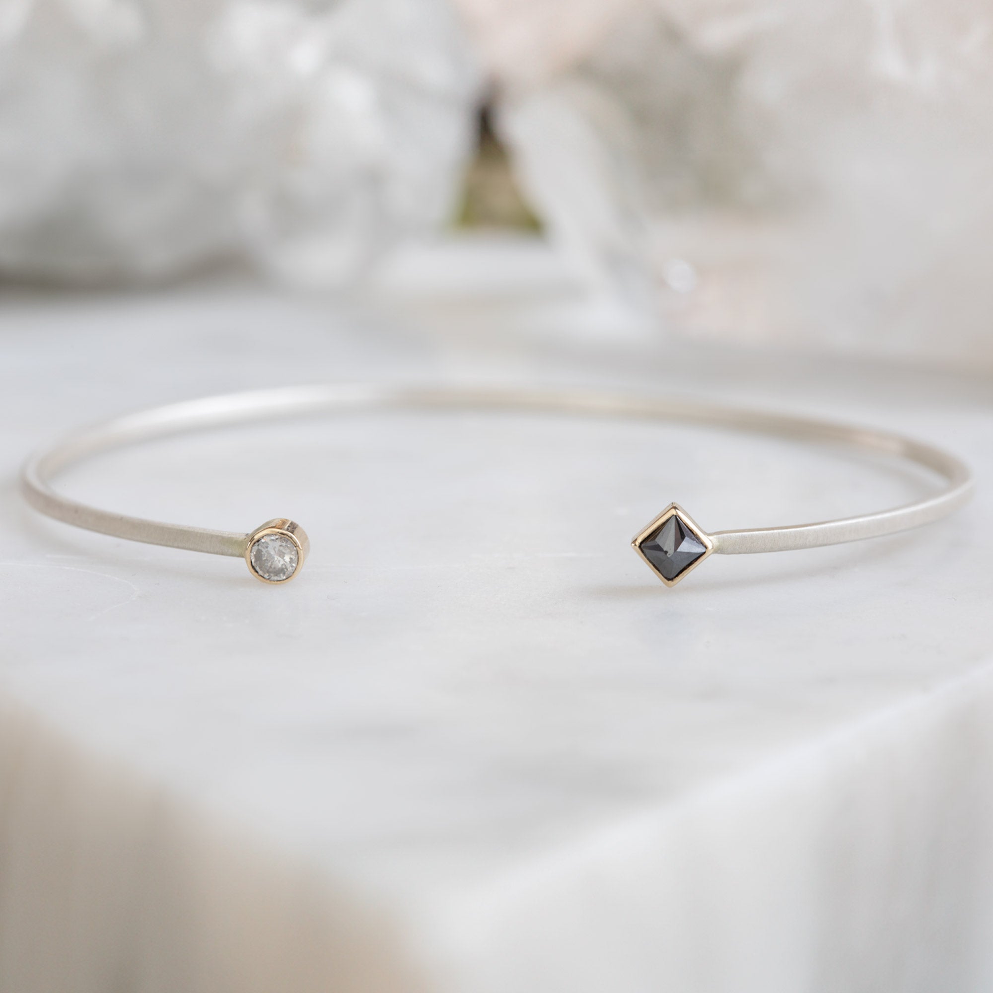 The Open Cuff Black + White Diamond Bracelet in Sterling Silver on White Marble