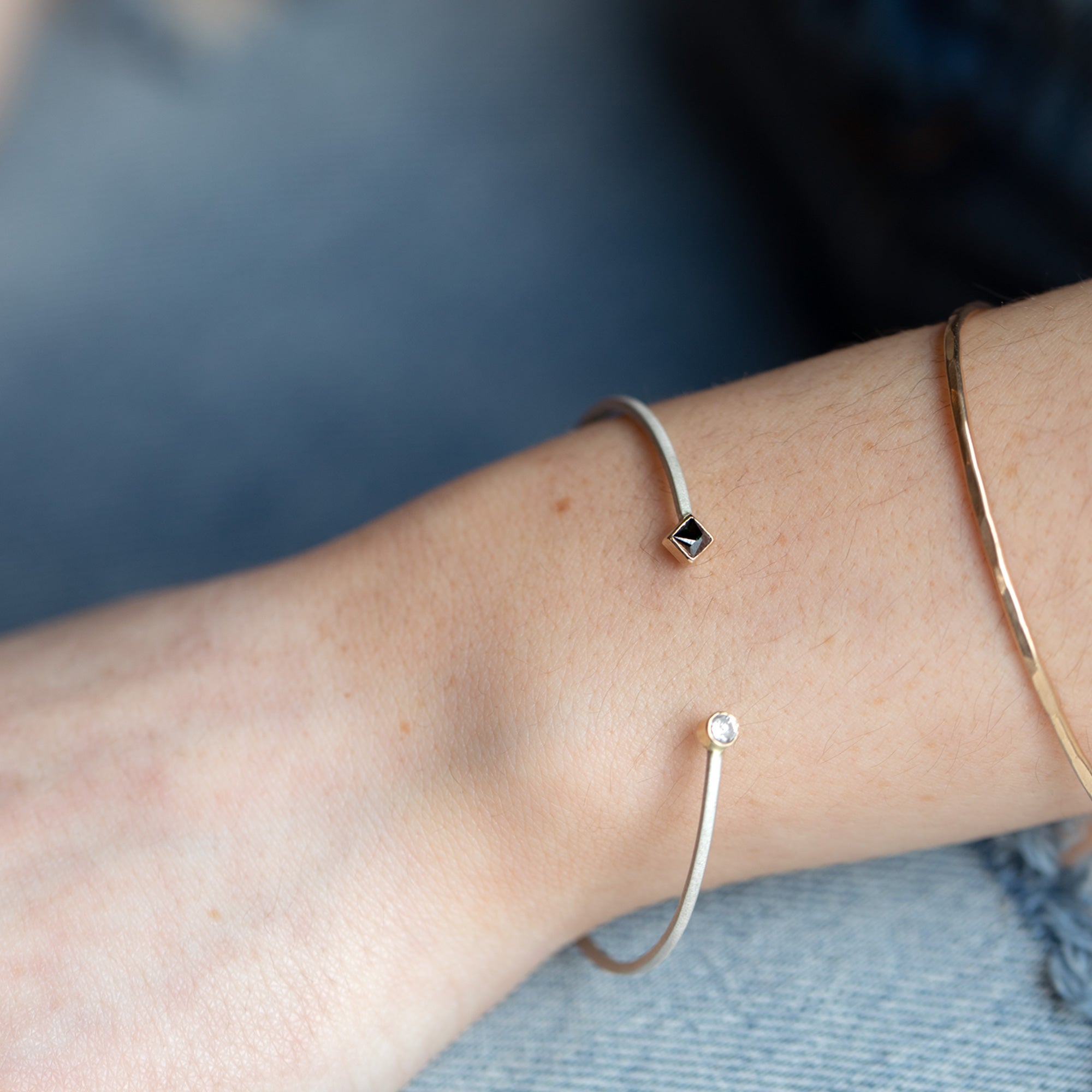 The Open Cuff Black + White Diamond Bracelet in Sterling Silver Stacked on Model