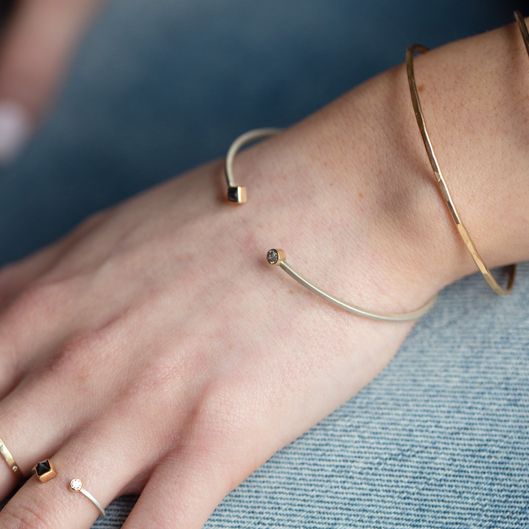 The Open Cuff Black + White Diamond Bracelet in Sterling Silver Stacked on Model