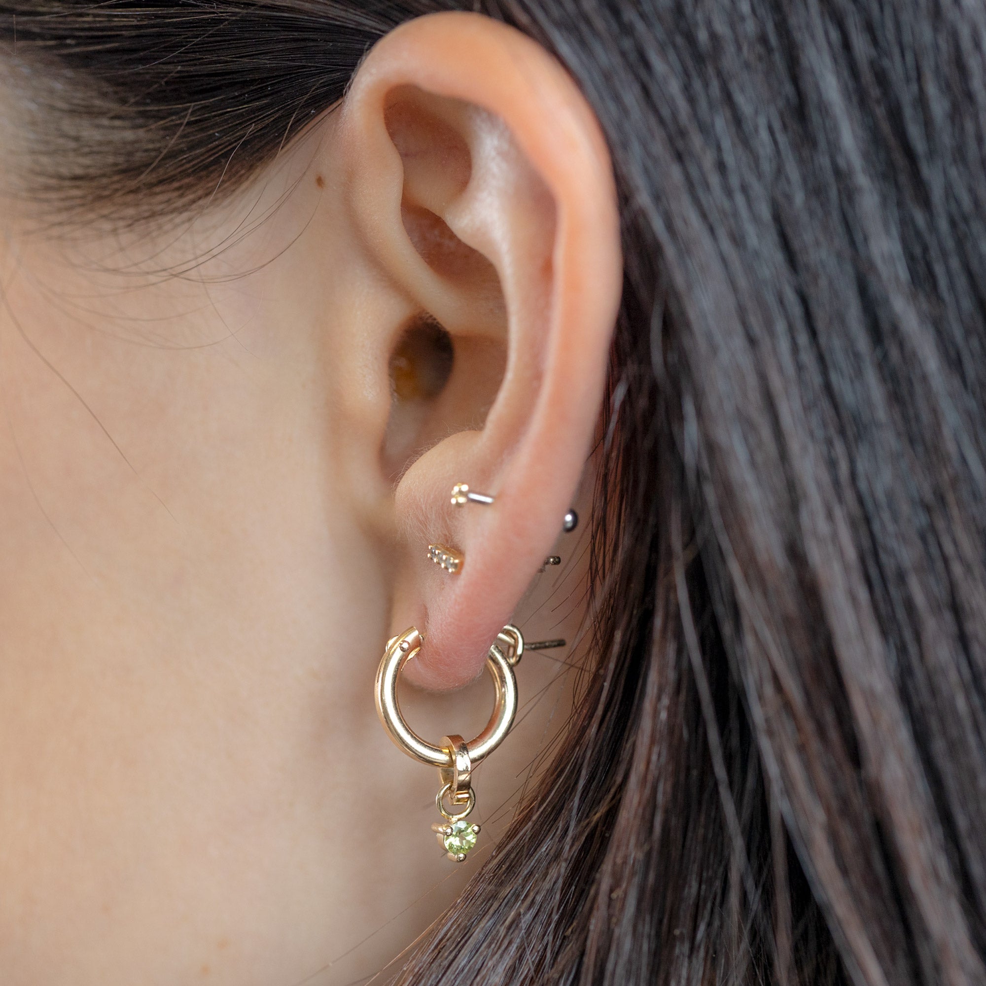 The Peridot Birthstone Charm in 10K Yellow Gold on Charm Hoop on Model