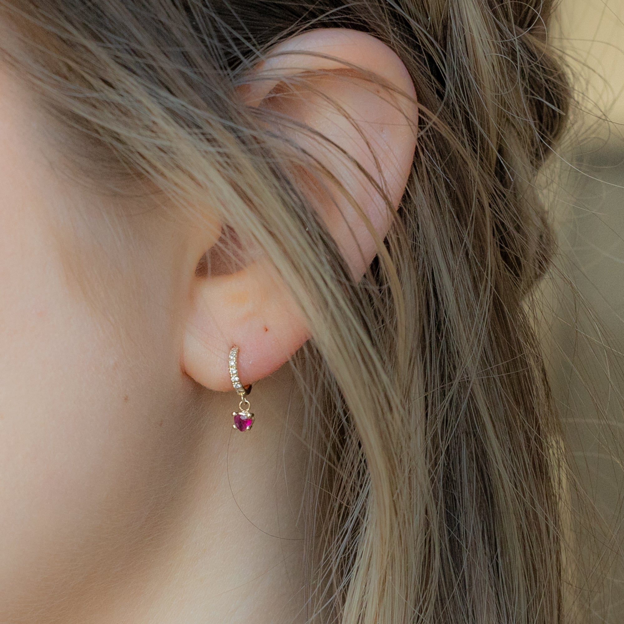The Ruby Heart + Diamond Huggie Studs in 14K Yellow Gold on Model