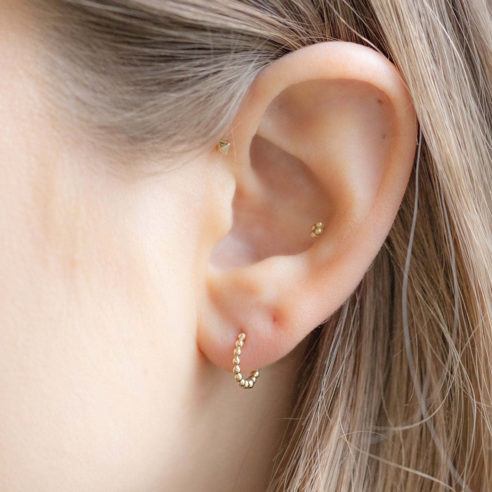 The Beaded Huggie Hoops in 14K Yellow Gold on Model