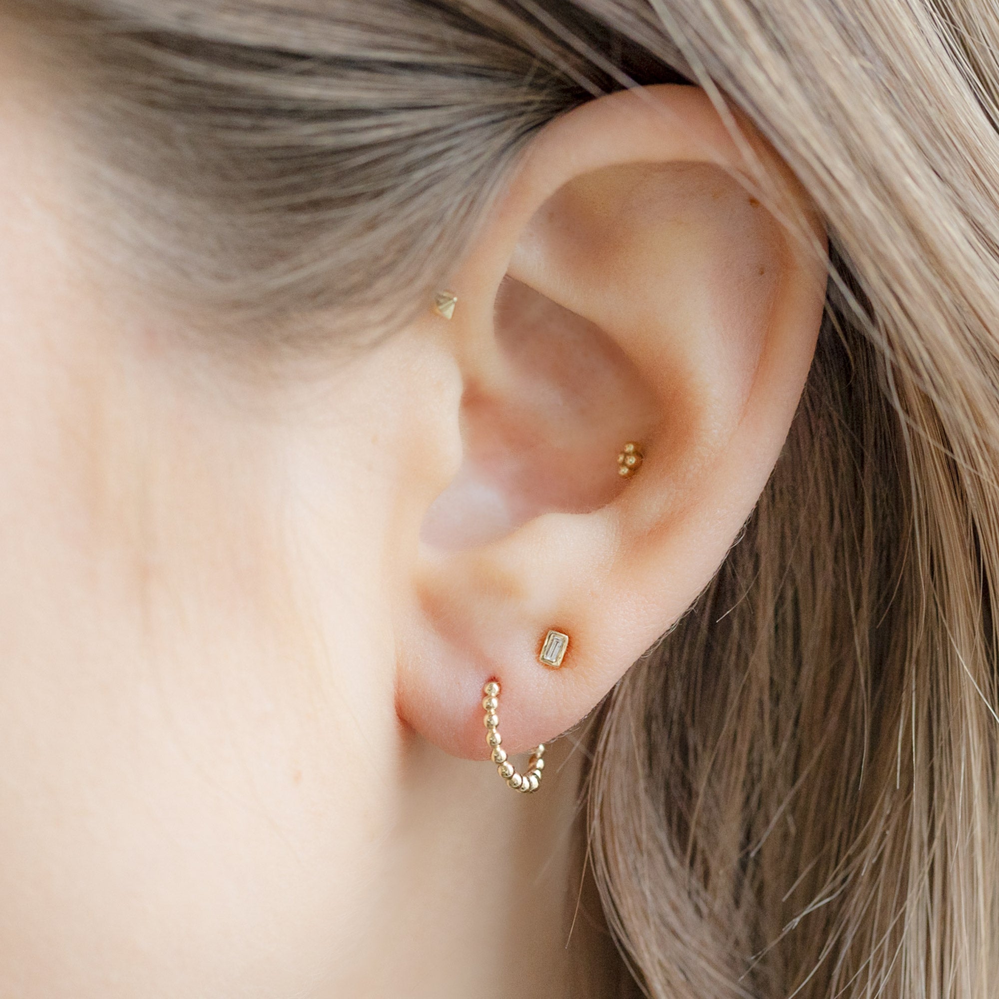 buy:the-white-diamond-baguette-stud-earrings-14k-yellow-gold,the-beaded-huggie-hoops-14k-yellow-gold