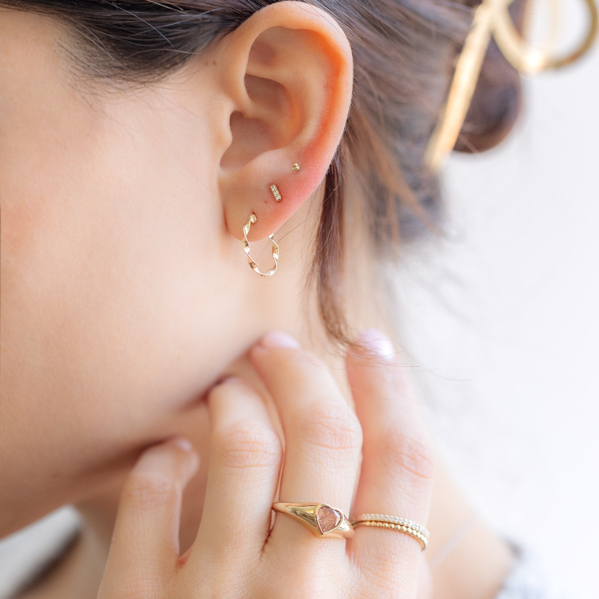 The Ribbon Hoops in 14K Yellow Gold stylized on model
