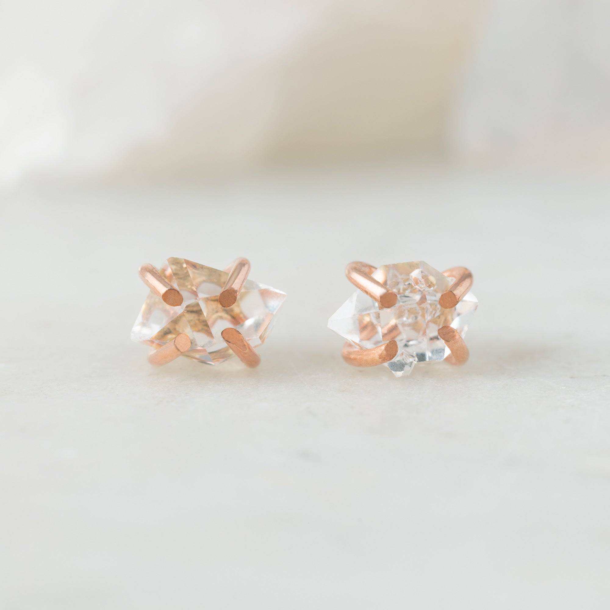 The Herkimer Diamond Stud Earrings in Rose Gold Filled on White Marble