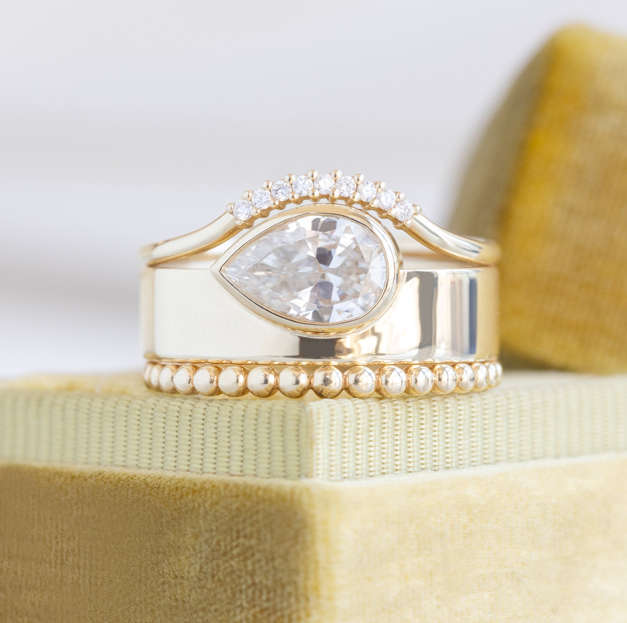 buy:white-diamond-pave-arc-stacking-band-14k-or-18k-yellow-gold,the-cigar-band-0-91ct-pear-white-diamond-in-14k-yellow-gold,the-gold-beaded-stacking-ring-14k-yellow-gold