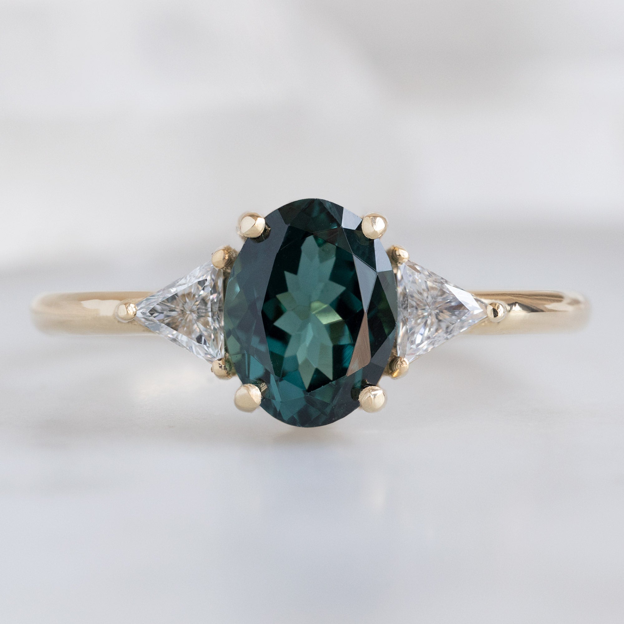 The Jade Ring with a 1.49ct Oval Cut Tourmaline in 14K Yellow Gold on White Marble