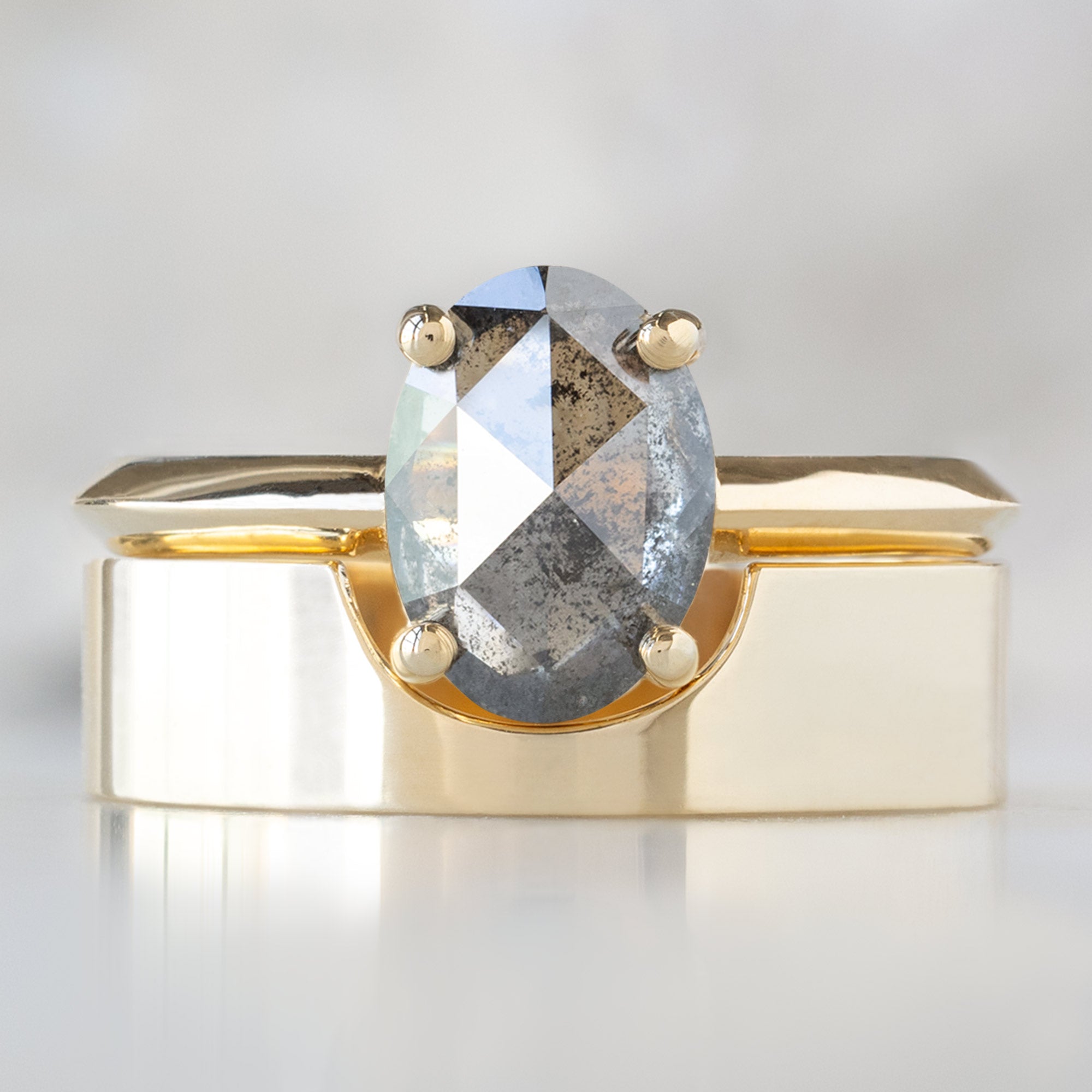 The Bryn Ring with a 1.41ct Oval Salt and Pepper Diamond in 14K Yellow Gold  Stacked with the Gold Cut-Out Stacking Band