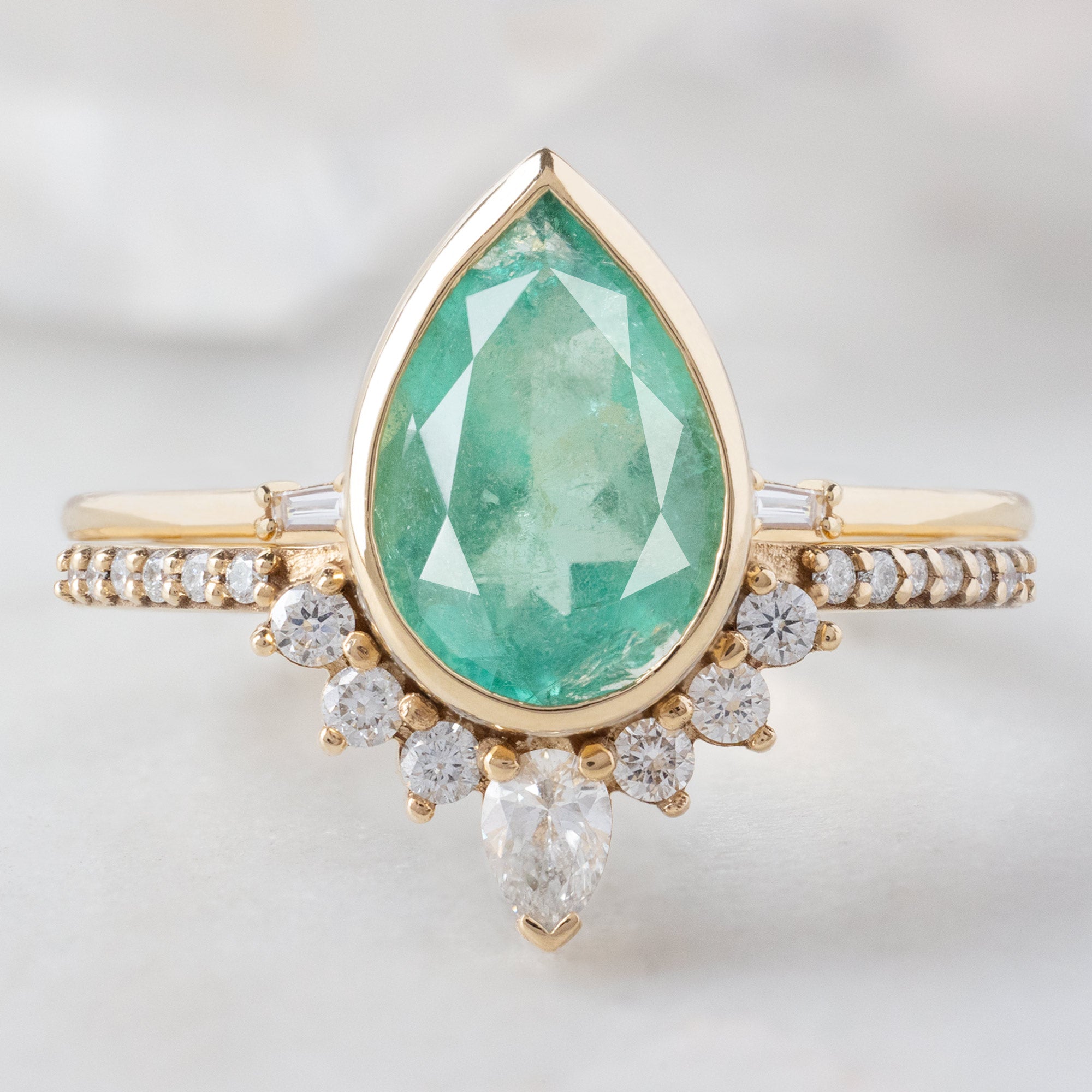 The Aster Ring with a 2.12ct Pear Emerald in 14K Yellow Gold  Stacked with the Open Cuff Baguette Stacking Band