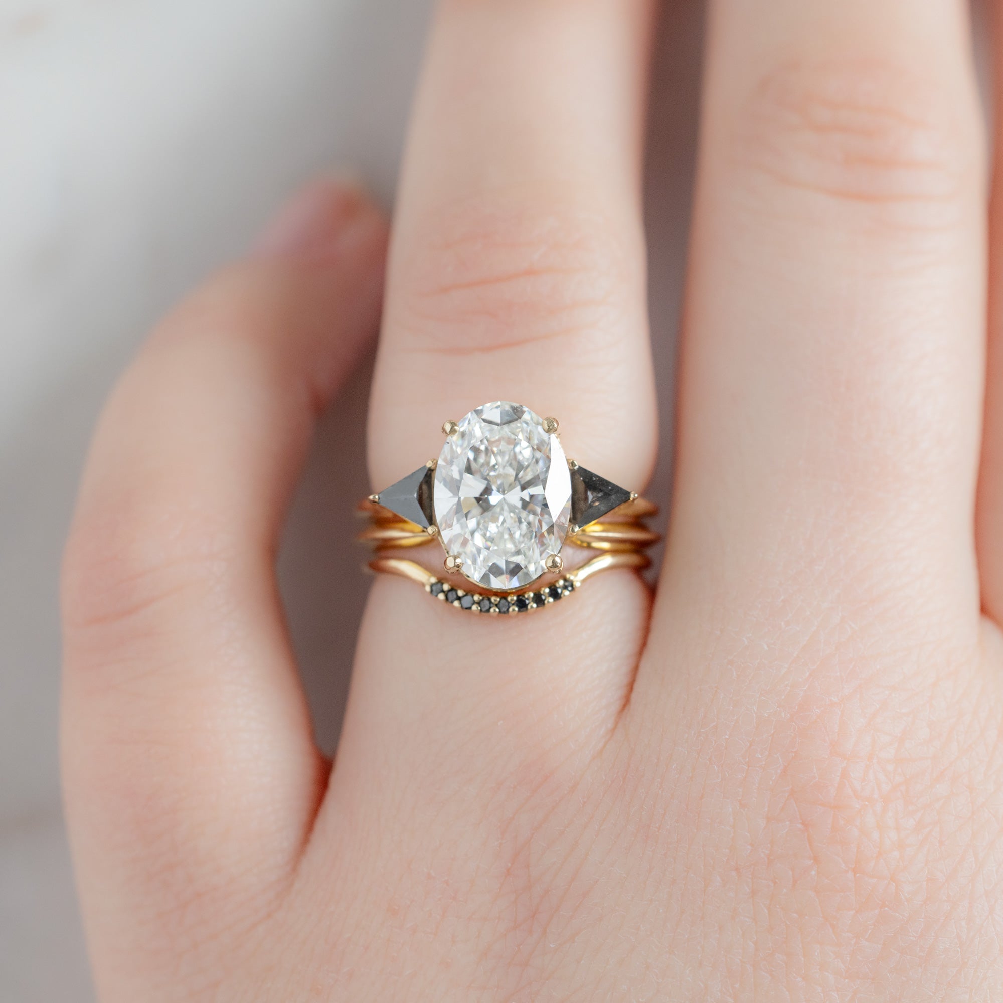 buy:the-jade-ring-3-39ct-oval-lab-grown-white-diamond-in-14k-yellow-gold,gold-open-cuff-knife-edge-stacking-band-14k-yellow-gold,black-diamond-pave-arc-stacking-band-14k-or-18k-rose-gold