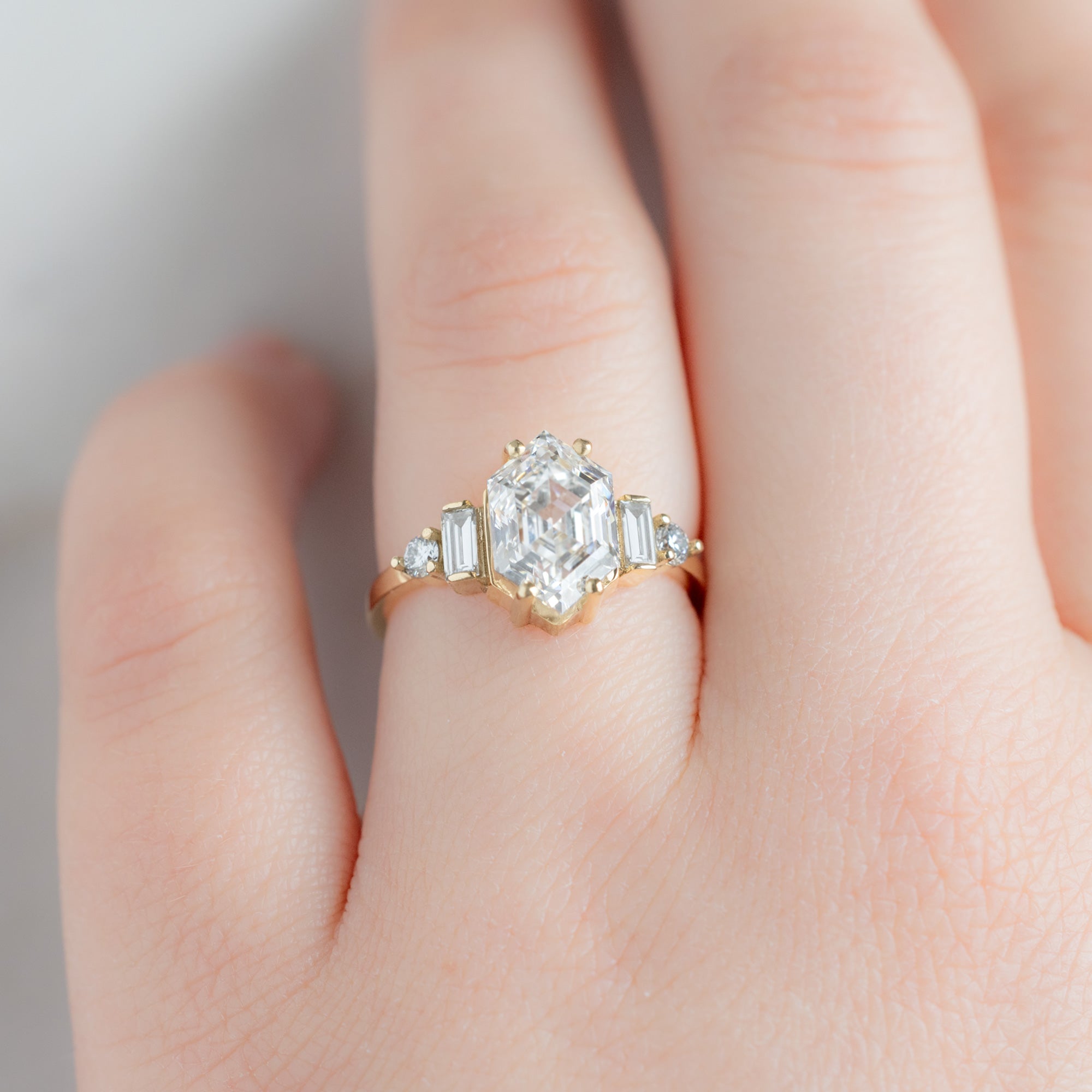 The Primrose Ring with a 2.64ct Hexagon Lab Grown White Diamond in 14K Yellow Gold on Model