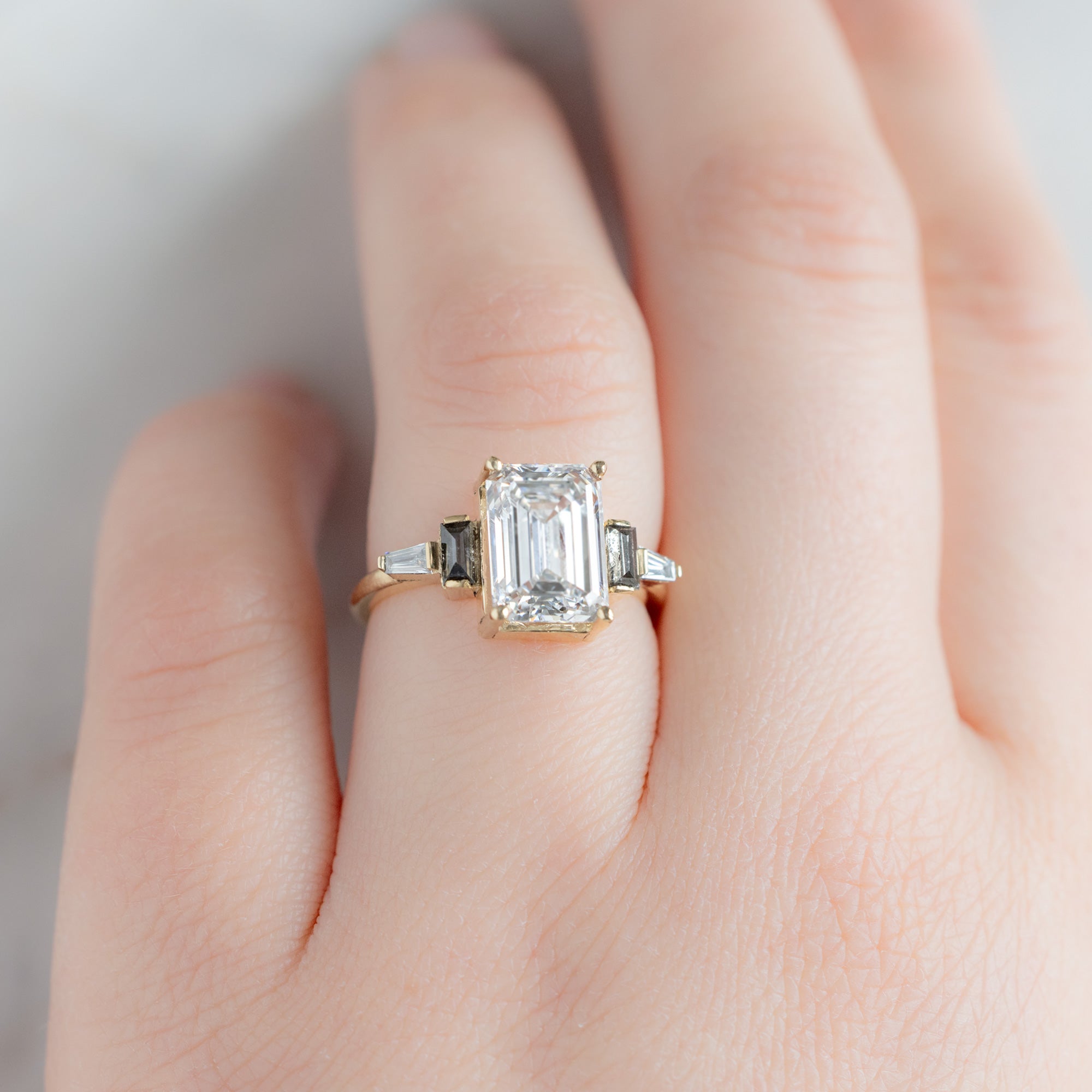The Deco Ring with a 3.39ct Emerald Cut Lab Grown White Diamond in 14K Yellow Gold on Model