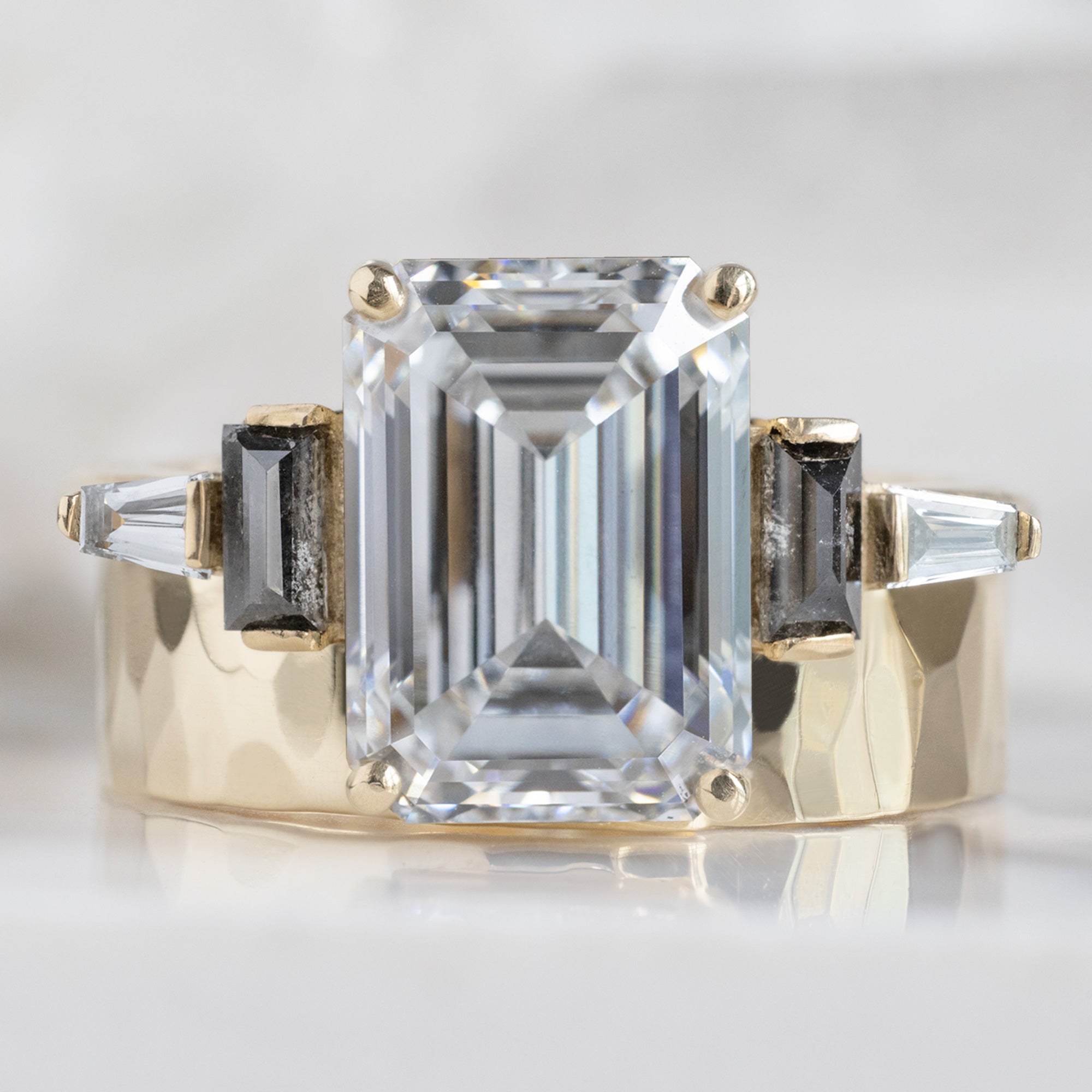 The Deco Ring with a 3.39ct Emerald Cut Lab Grown White Diamond in 14K Yellow Gold Stacked with the Cut Out Stacking Band