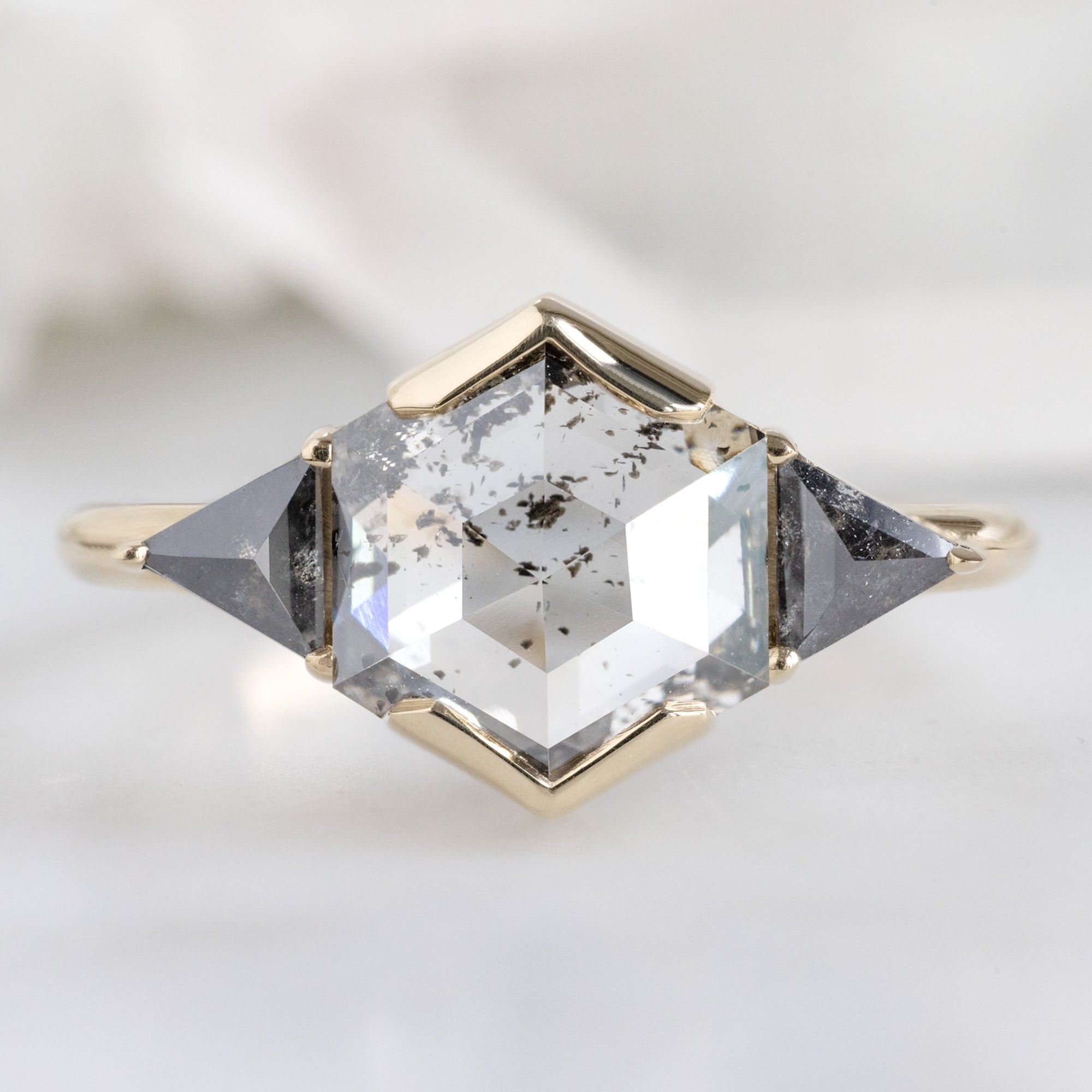 The Jade Ring with a 1.72ct Hexagon Lab Grown Salt and Pepper Diamond in 14K Yellow Gold on White Marble