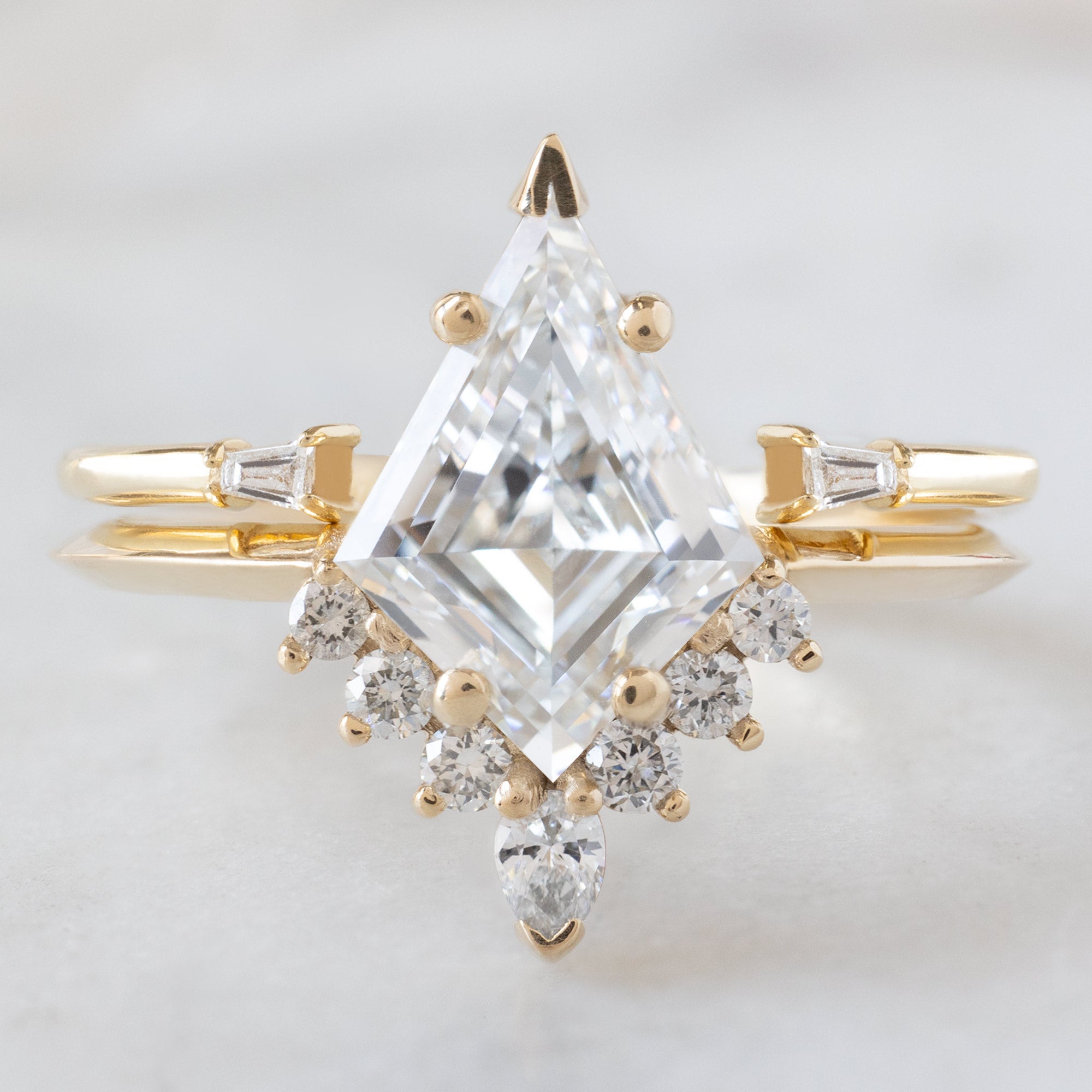 The Aster Ring with a 1.75ct Lab Grown Kite White Diamond in 14K Yellow Gold stacked with the Open Cuff White Diamond Baduette Stacking Band