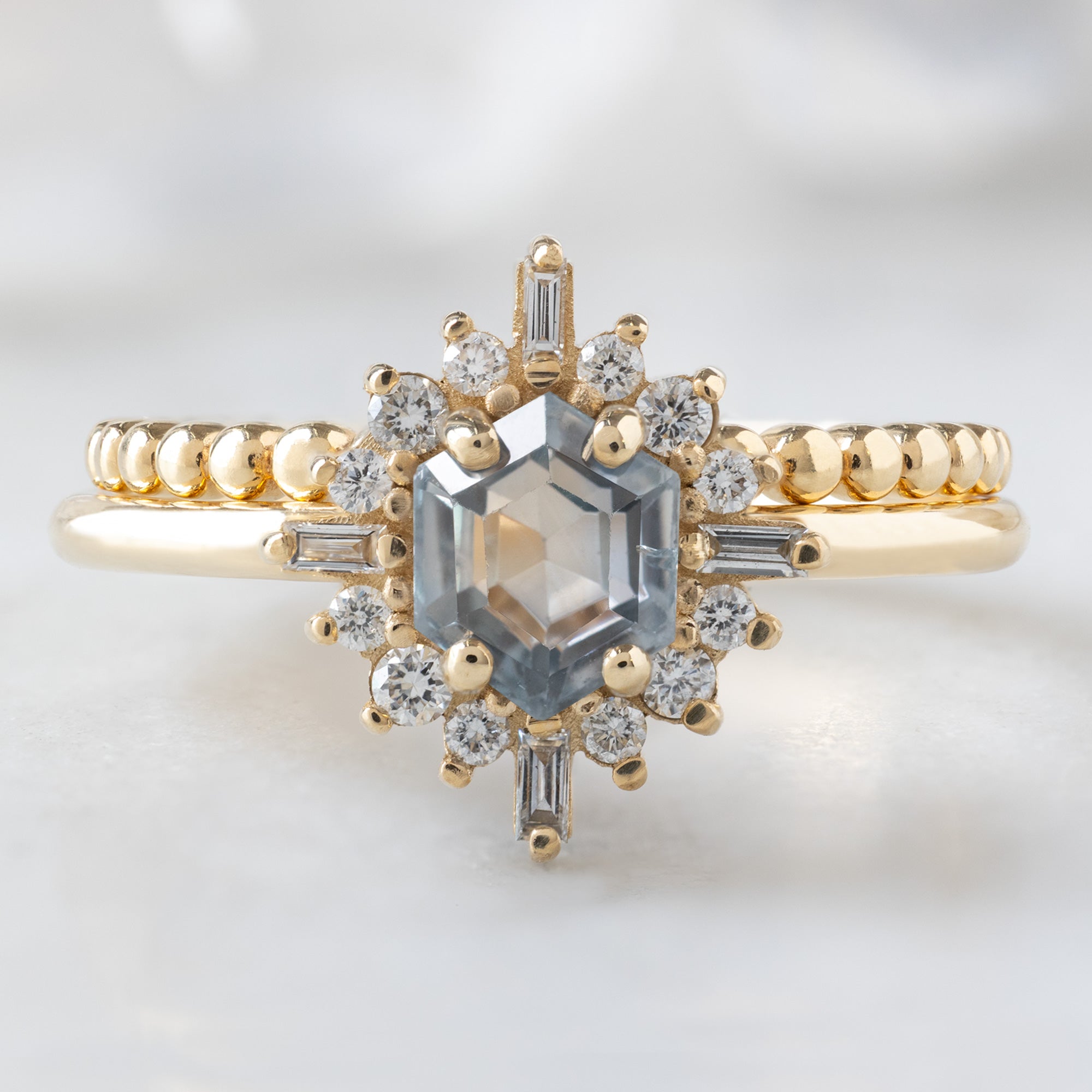 The Compass Ring with a 0.75ct Hexagon Grey Sapphire in 14K Yellow Gold Stacked with the Beaded Stacking Band