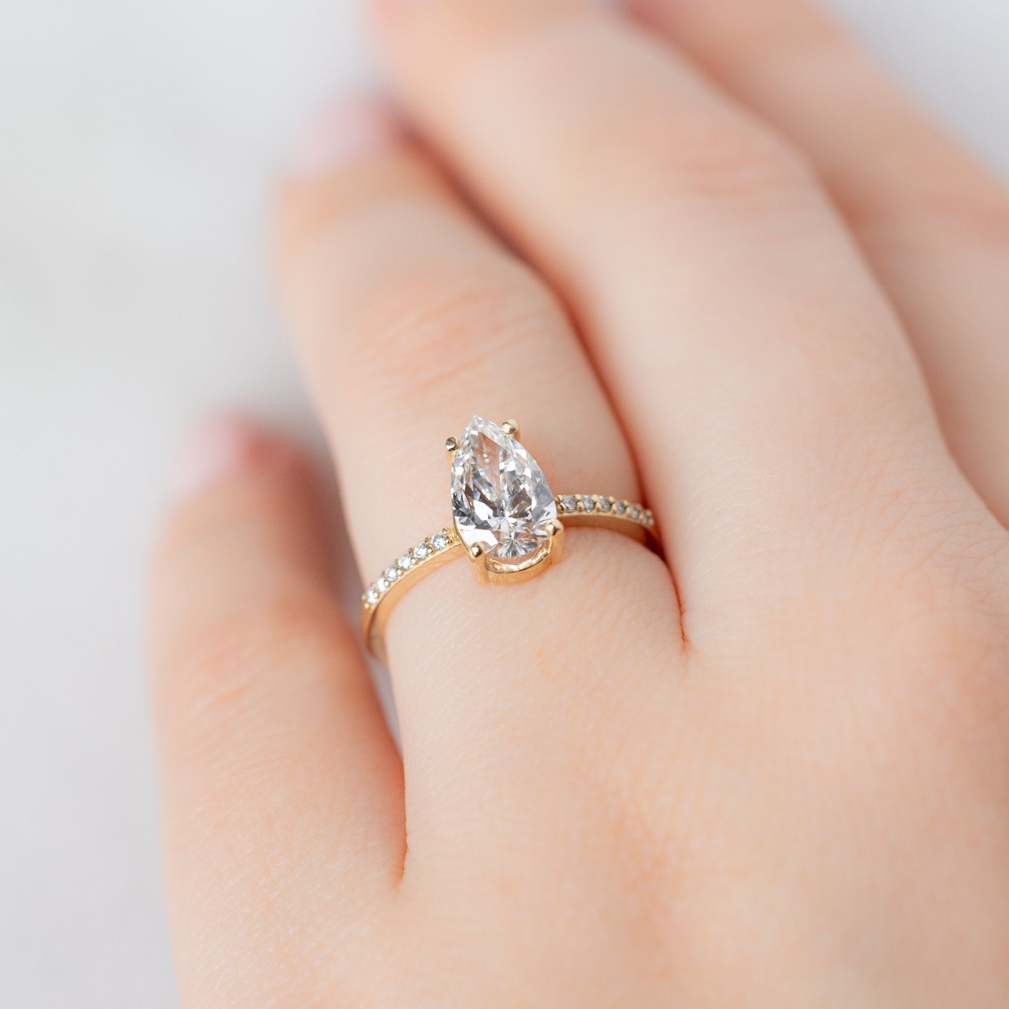 The Willow Ring with a Lab Grown Pear White Diamond in 14K Yellow Gold on Model