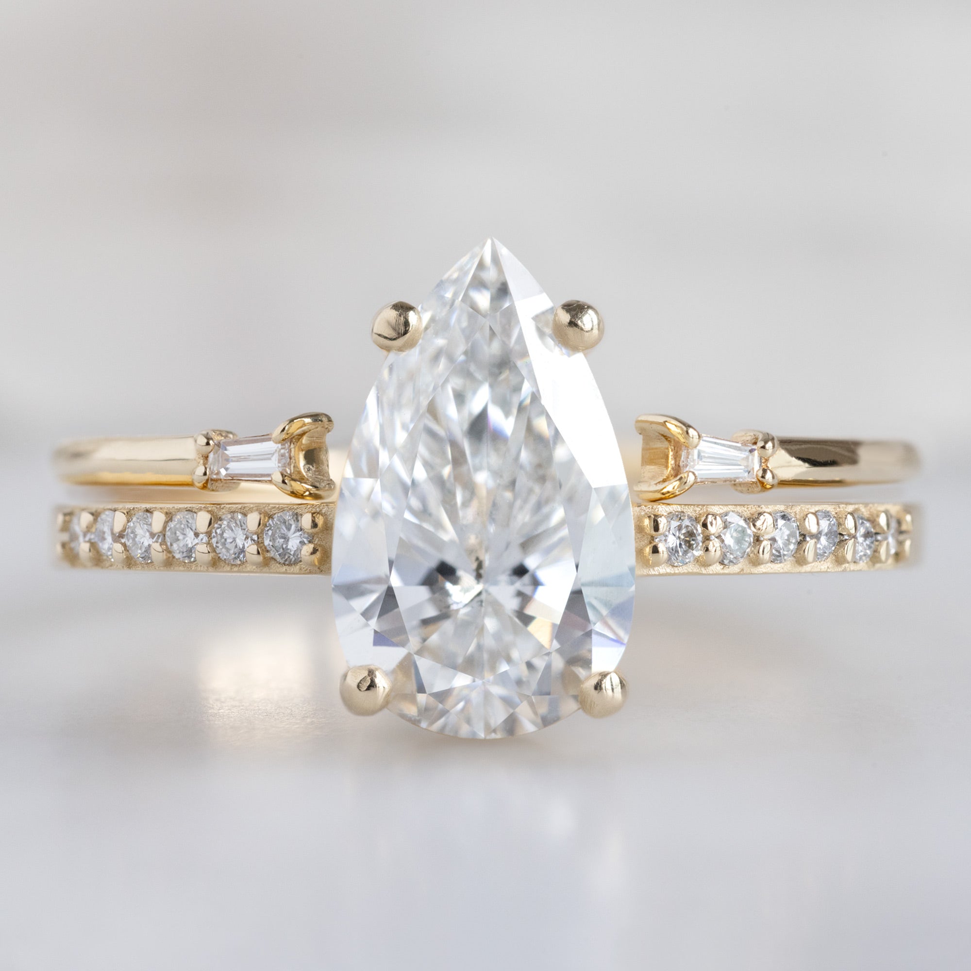 The Willow Ring with a Lab Grown Pear White Diamond in 14K Yellow Gold Stacked with the Open Cuff Baguette White Diamond Stacking Band