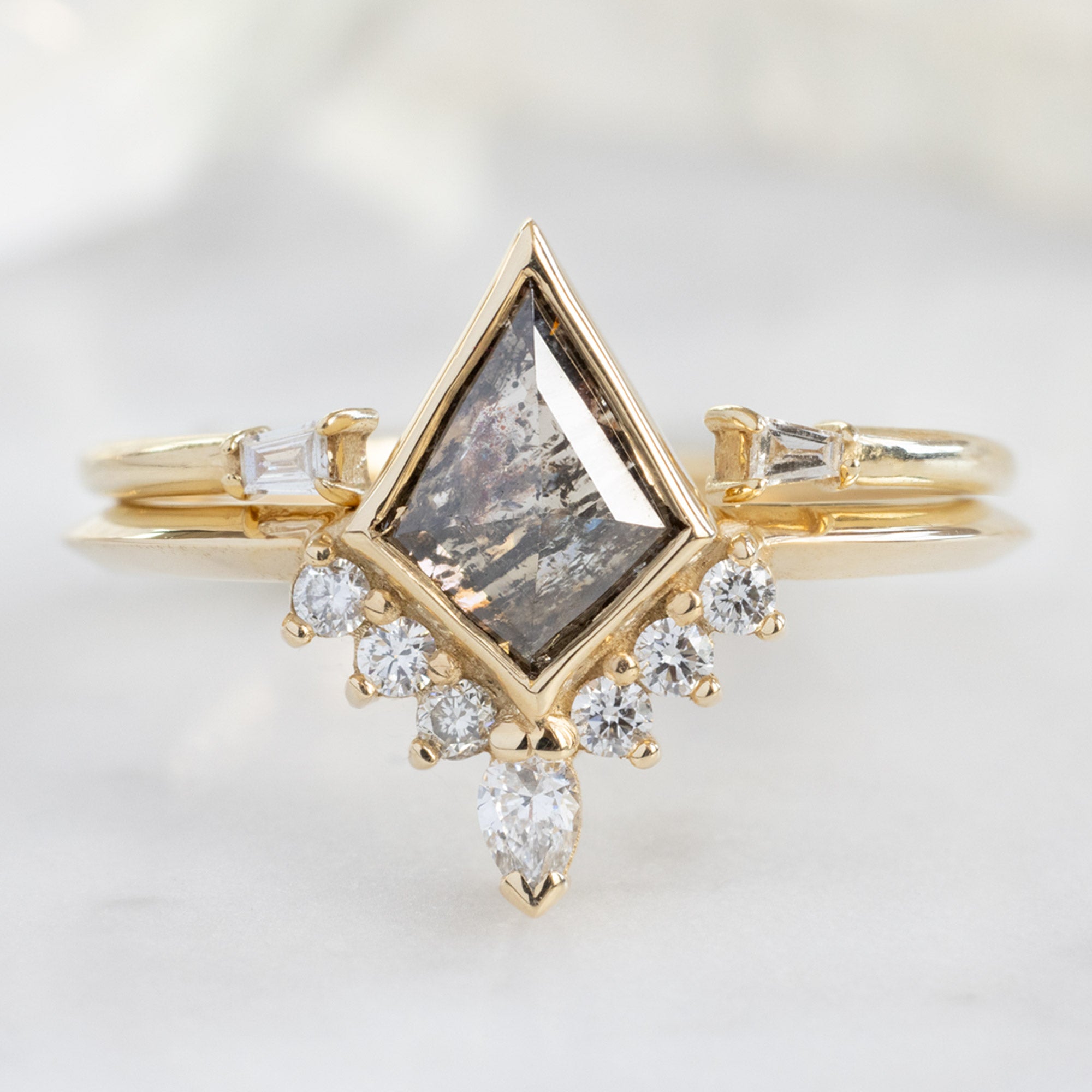 The Aster Ring with a Salt and Pepper Kite Diamond in 14K Yellow Gold Stacked with the Open Cuff White Baguette Stacking Band