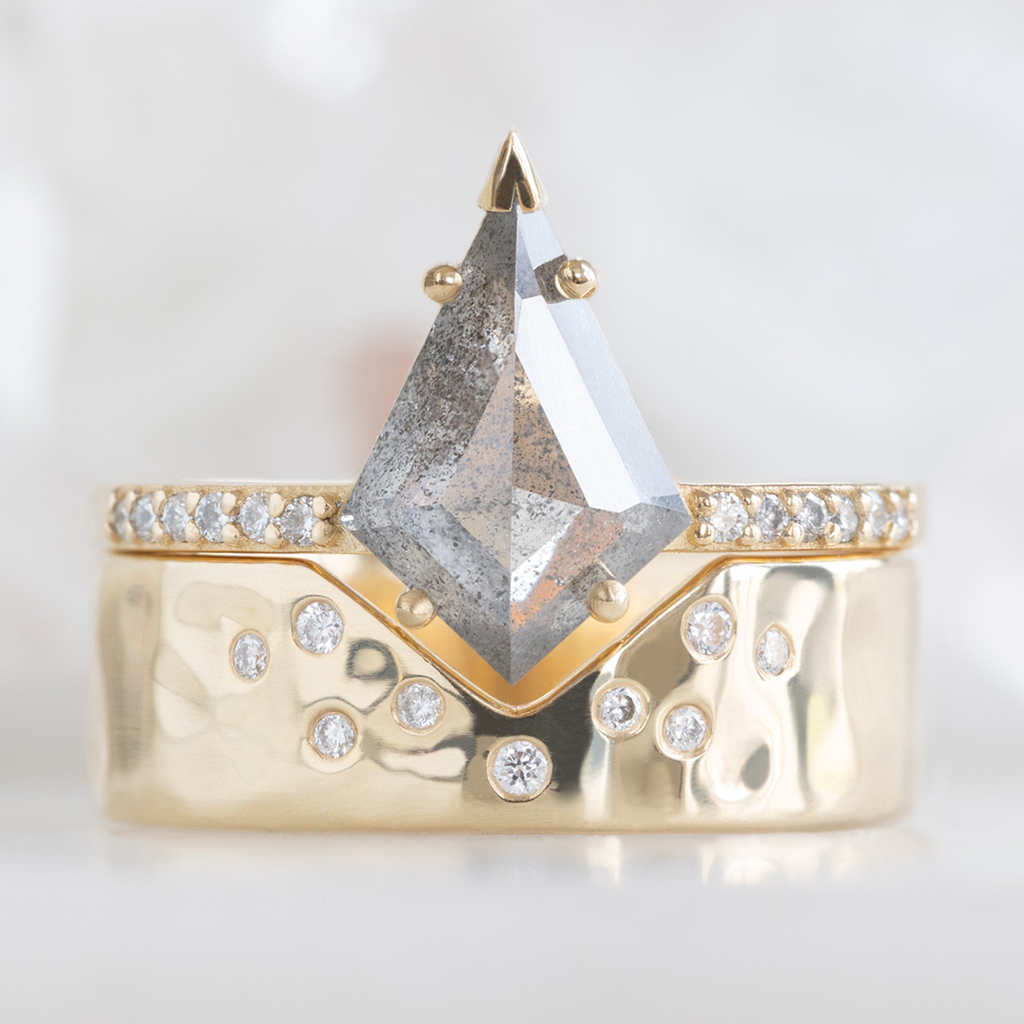 The Willow Ring with a Kite Shaped Salt and Pepper Diamond in 14K Yellow Gold Stacked with the Constellation Cut Out Peak Stacking Band