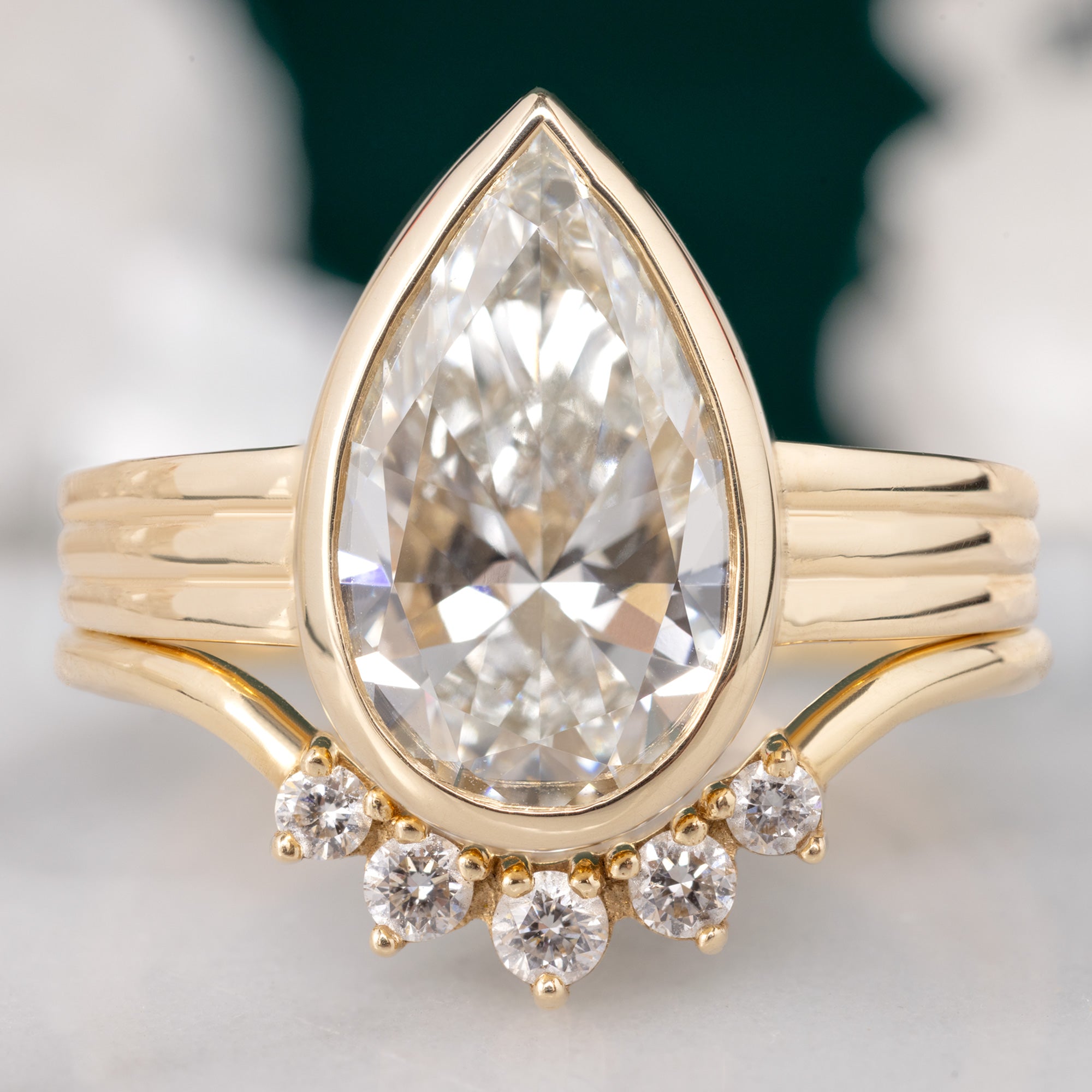 The Stratum Ring with a 3.02ct Pear Lab Grown White Diamond in 14K Yellow Gold Stacked with the Round White Diamond Sunburst Stacking Band