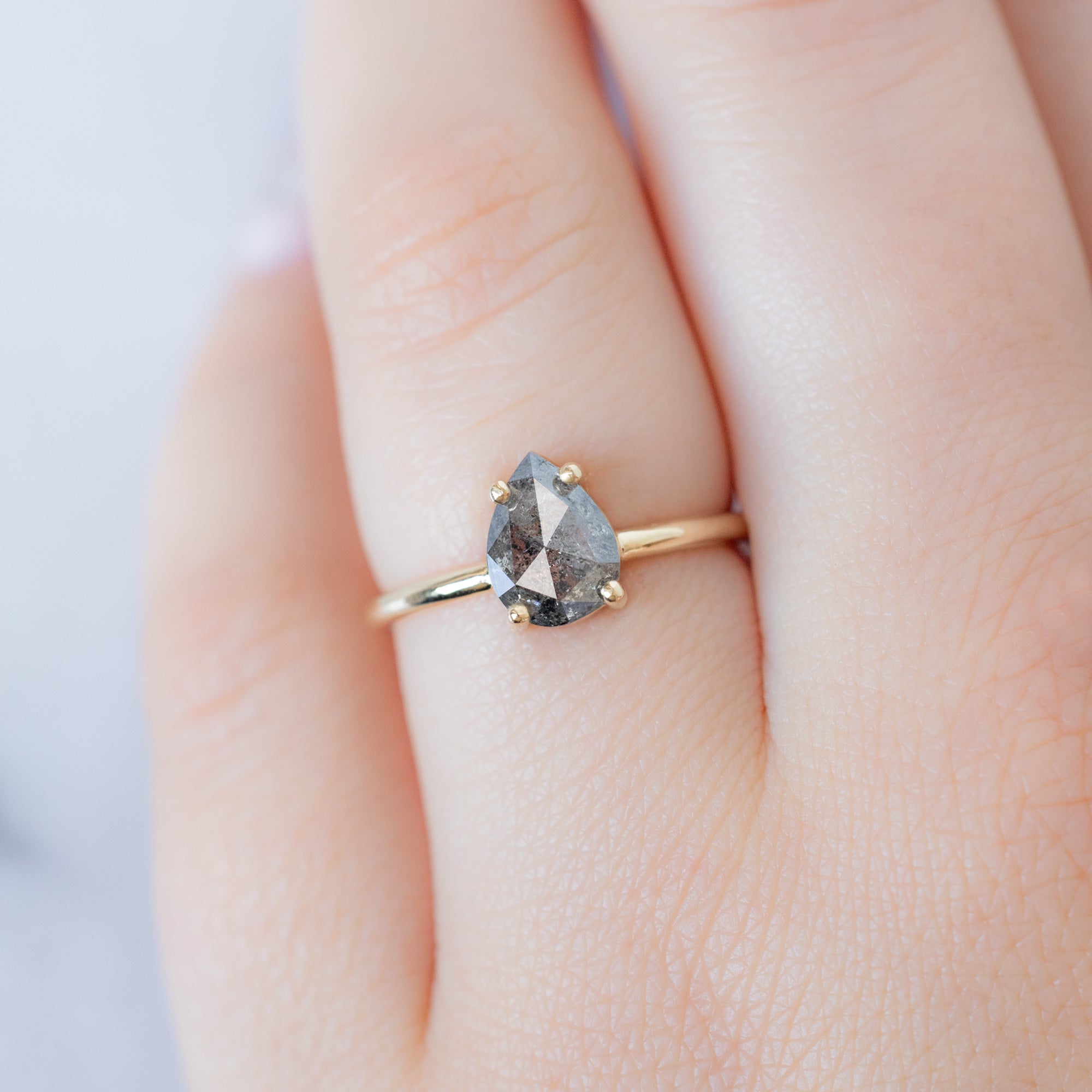 The Bryn Ring with a 1.25ct Pear Salt and Pepper Diamond in 14K Yellow Gold on Model