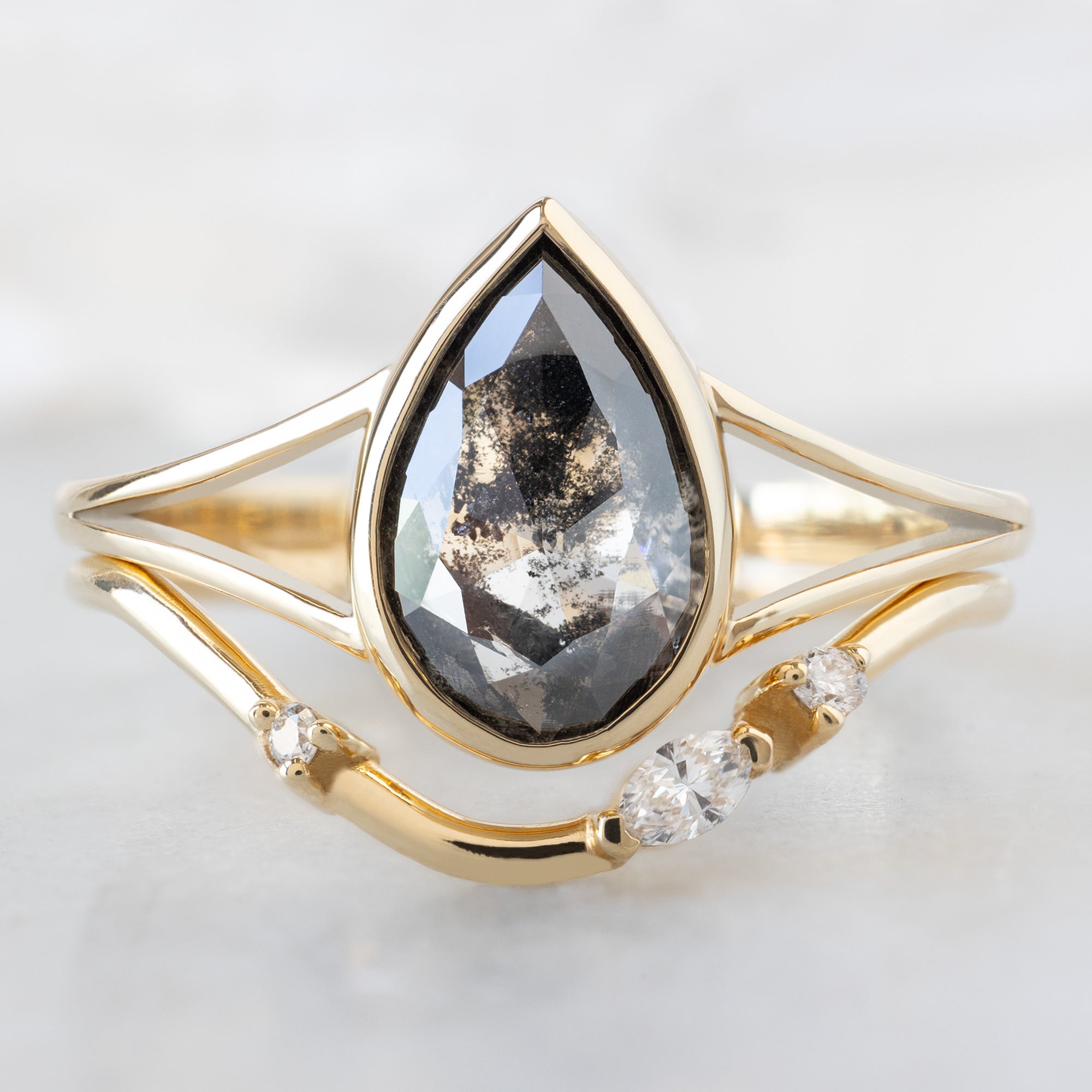 The Magnolia Ring with a 1.44ct Lab Grown Salt and Pepper Pear Diamond in 14K Yellow Gold  Stacked with the Asymmetrical Marquise Diamond Arc Stacking Band
