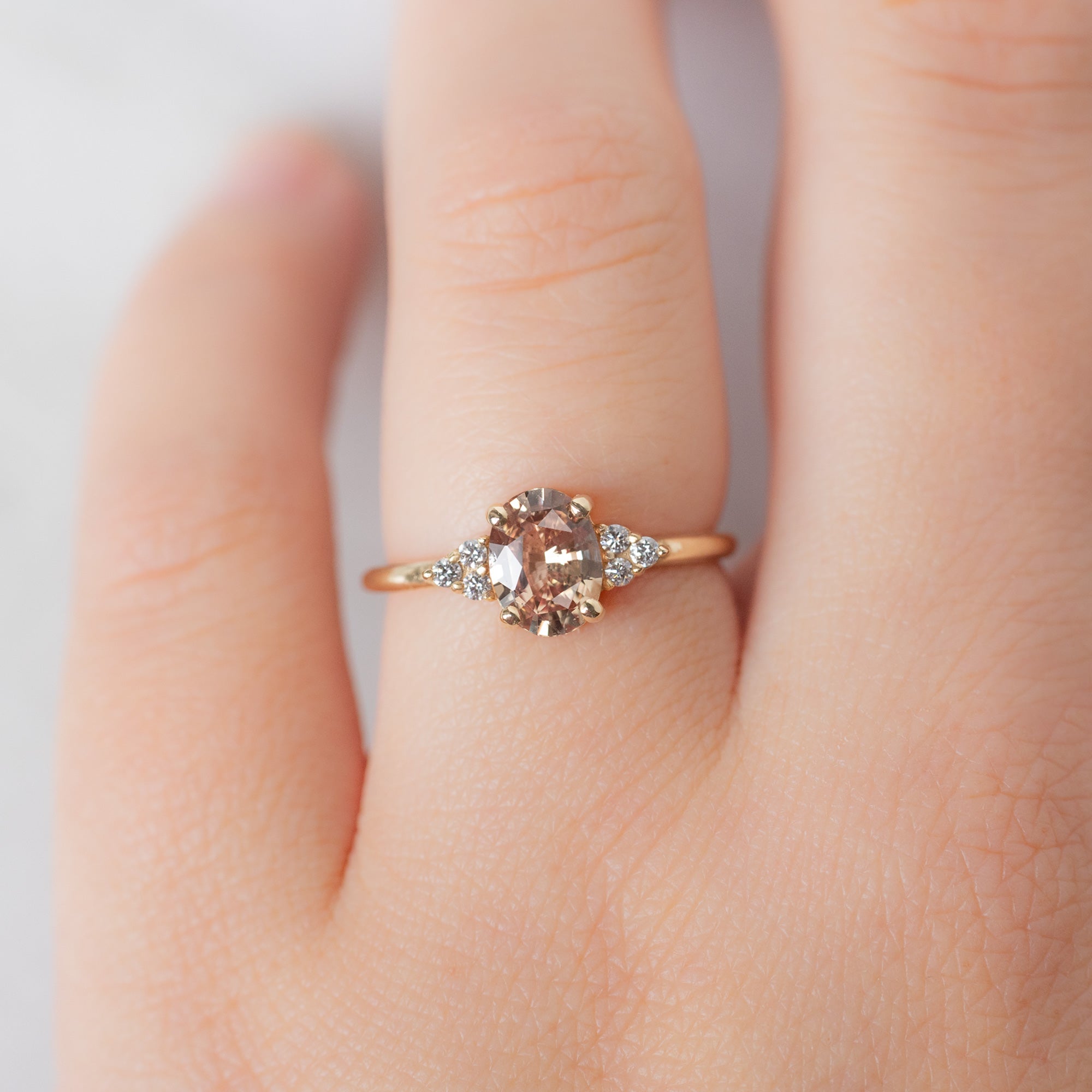 The Ivy Ring with a 1.13ct Oval Peach Sapphire in 14K Yellow Gold on Model