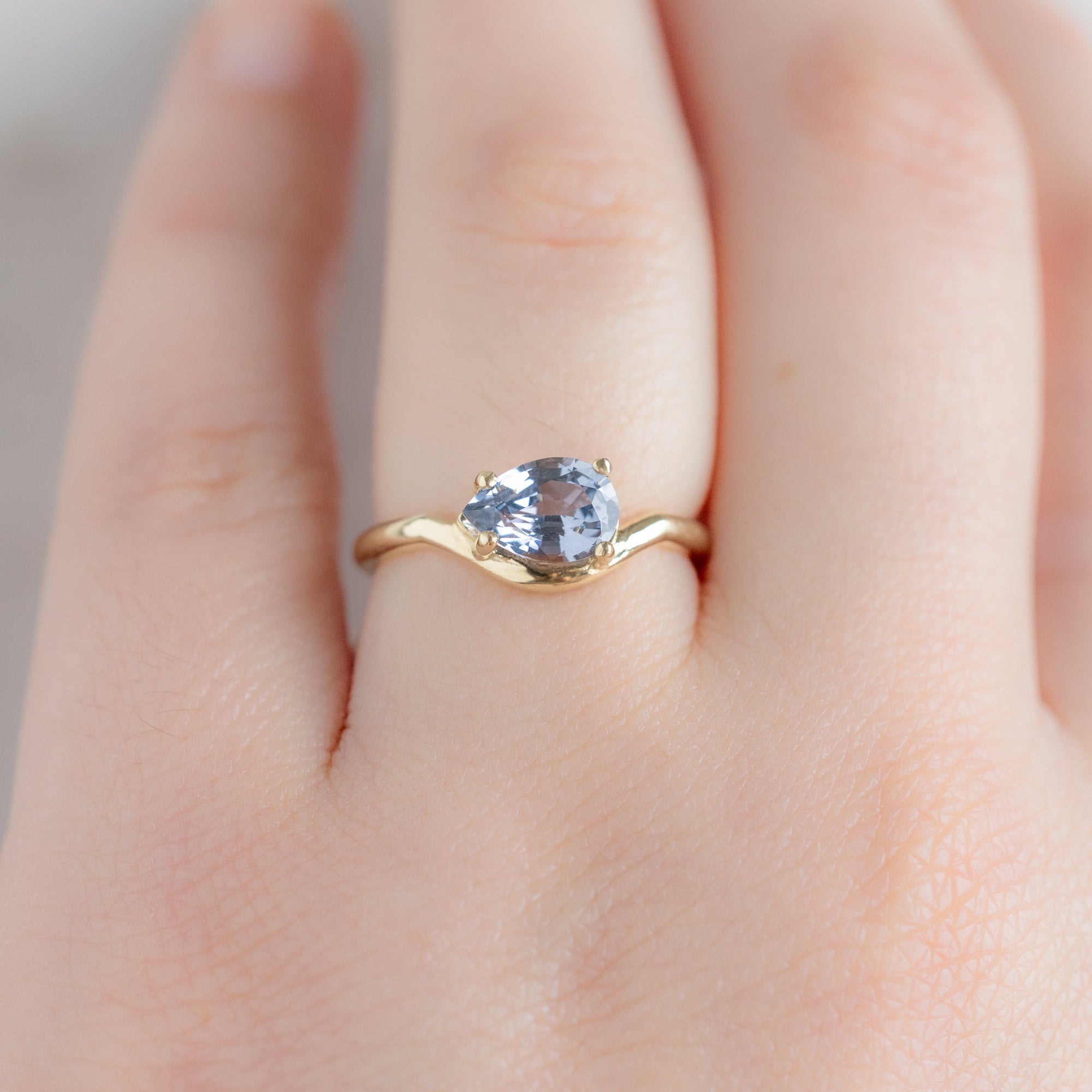The Wave Ring with a 1.29ct Pear Lavender Spinel in 14k Yellow Gold on Model
