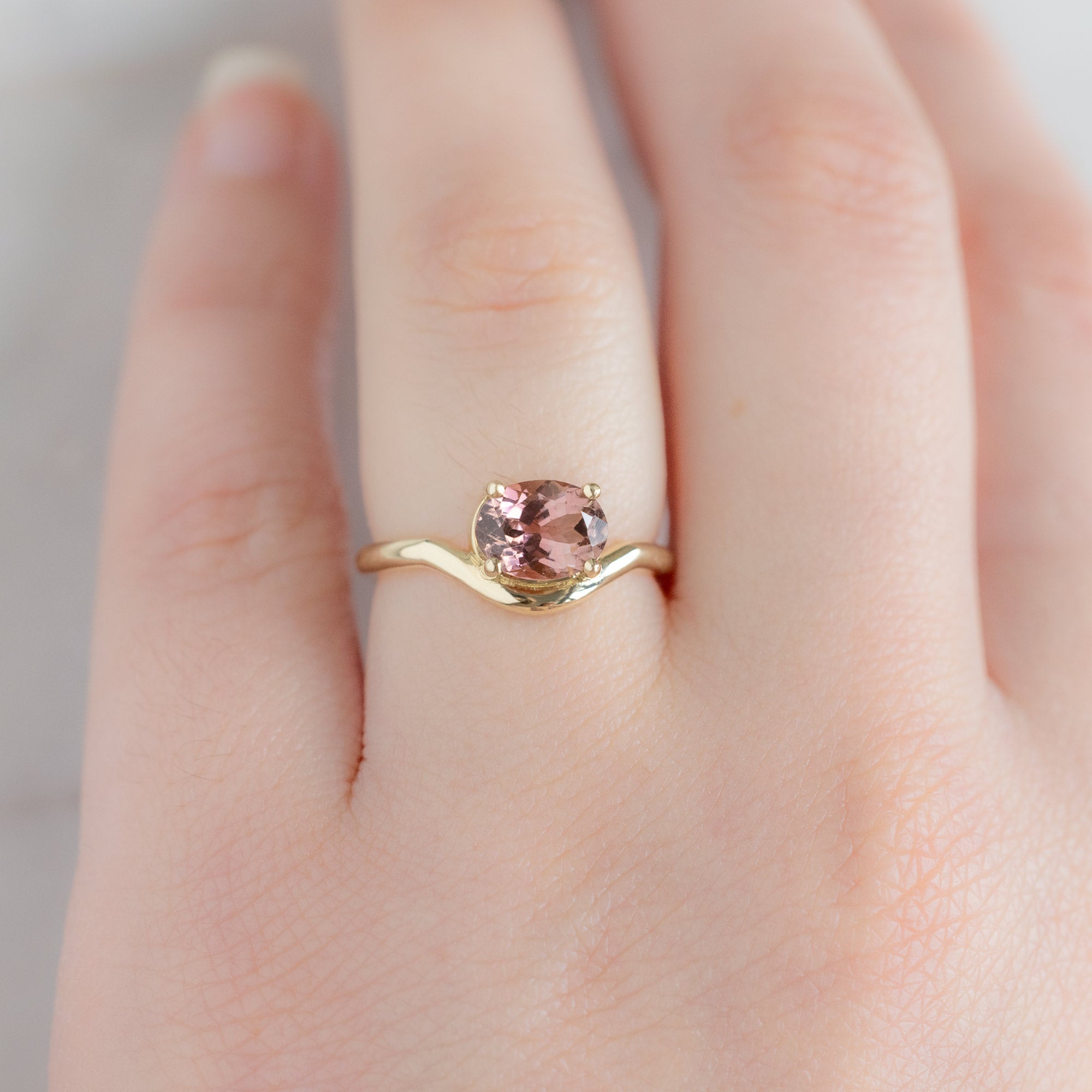 The Wave Ring with a 1.35ct Oval Pink Tourmaline in 14k Yellow Gold on Model