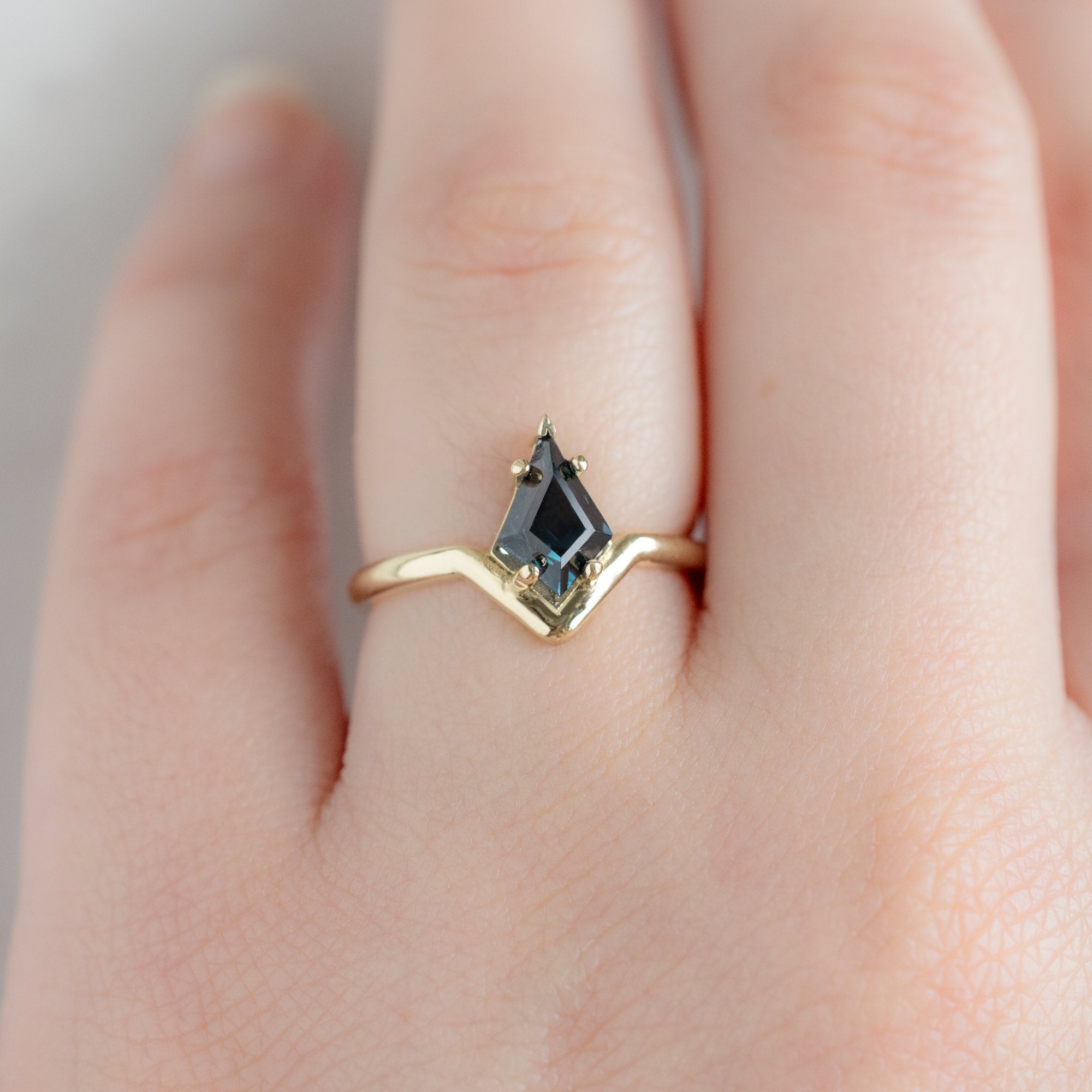 The Wave Ring with a 1.08ct Kite Blue Spinel in 14k Yellow Gold on Model