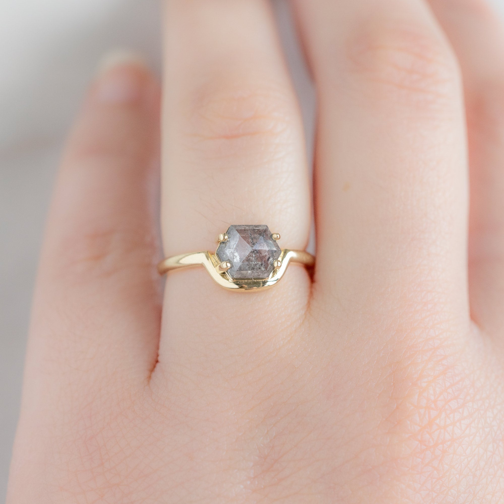 The Wave Ring with a 1.37ct Hexagon Salt and Pepper Diamond in 14K Yellow Gold on Model