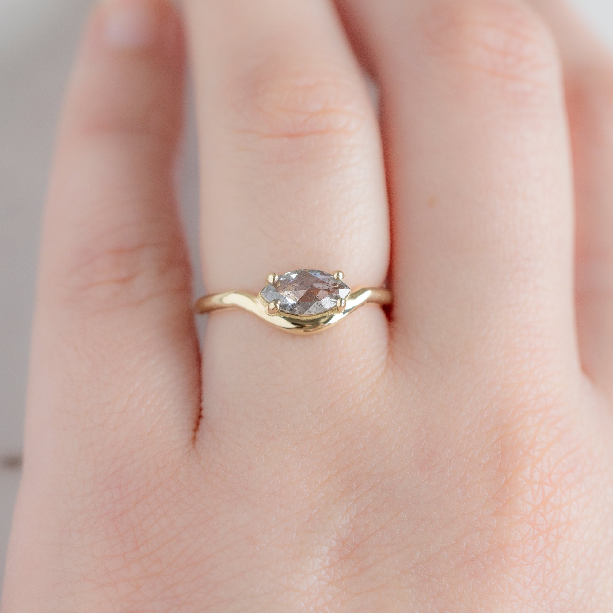 The Wave Ring with a 0.72ct Marquise Salt and Pepper Diamond in 14K Yellow Gold on Model
