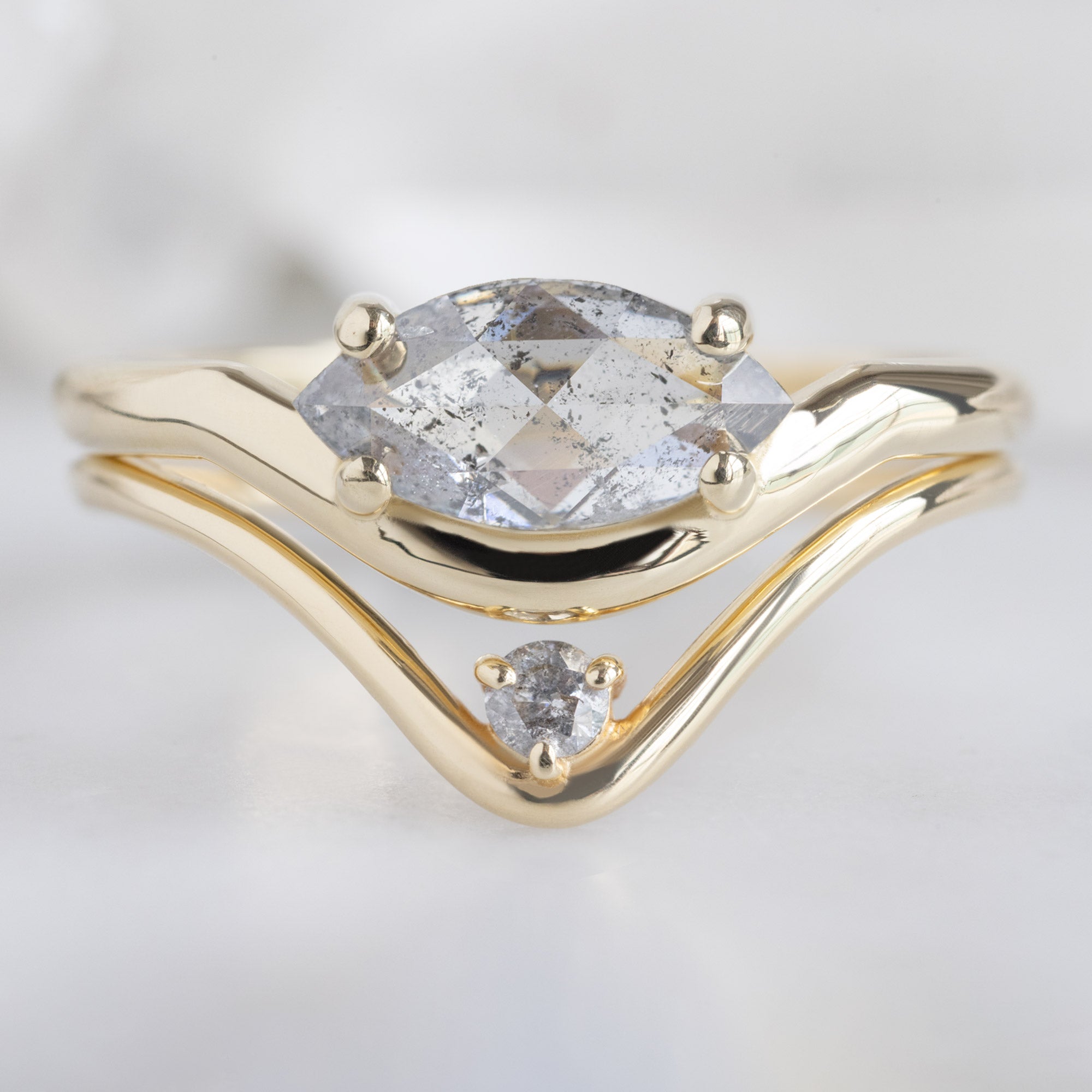 The Wave Ring with a 0.72ct Marquise Salt and Pepper Diamond in 14K Yellow Gold Stacked with the Salt and Pepper Diamond Peak Band