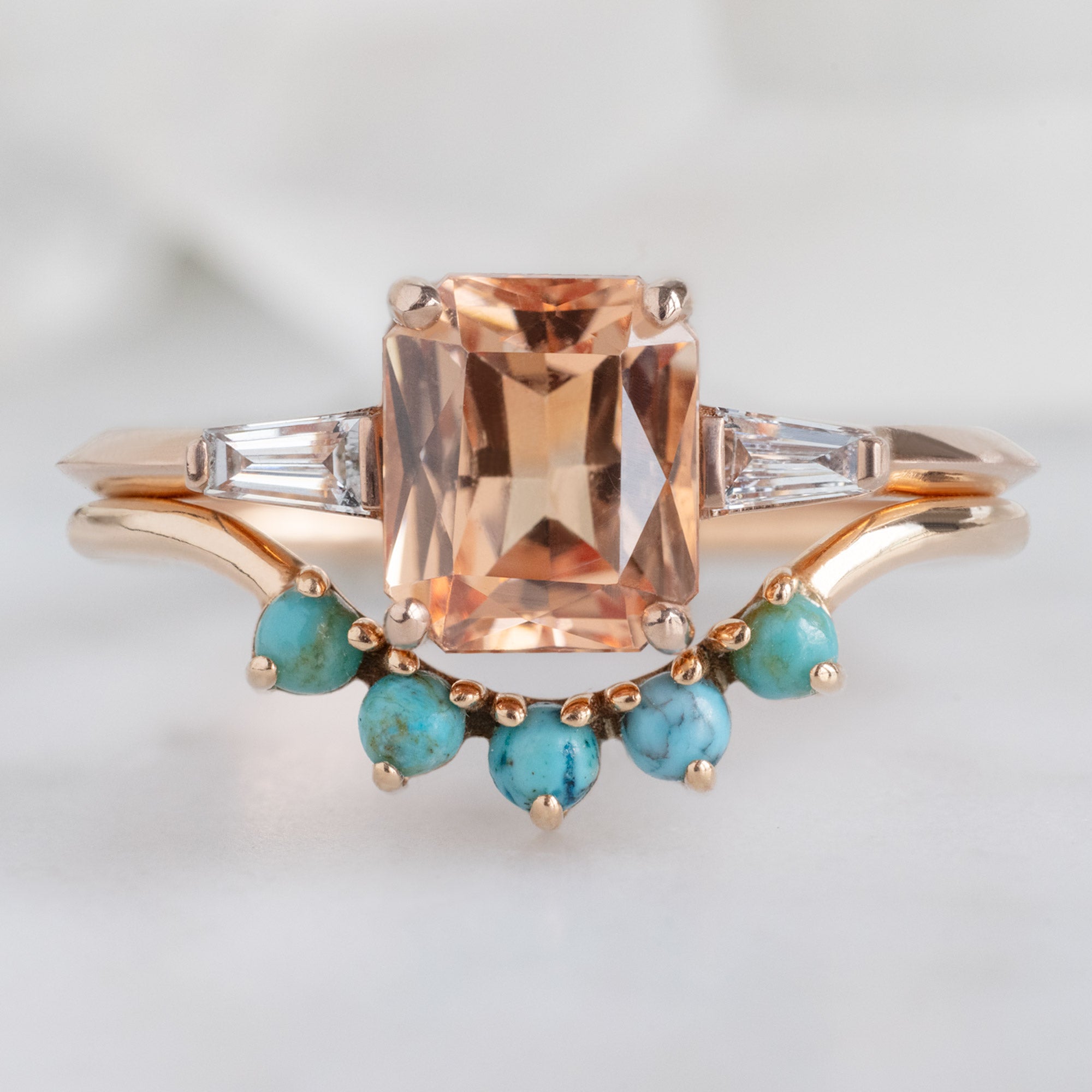 The Ash Ring with a 1.43ct Emerald Cut Garnet in 14K Rose Gold Stacked with Round Turquoise Sunburst Stacking Band