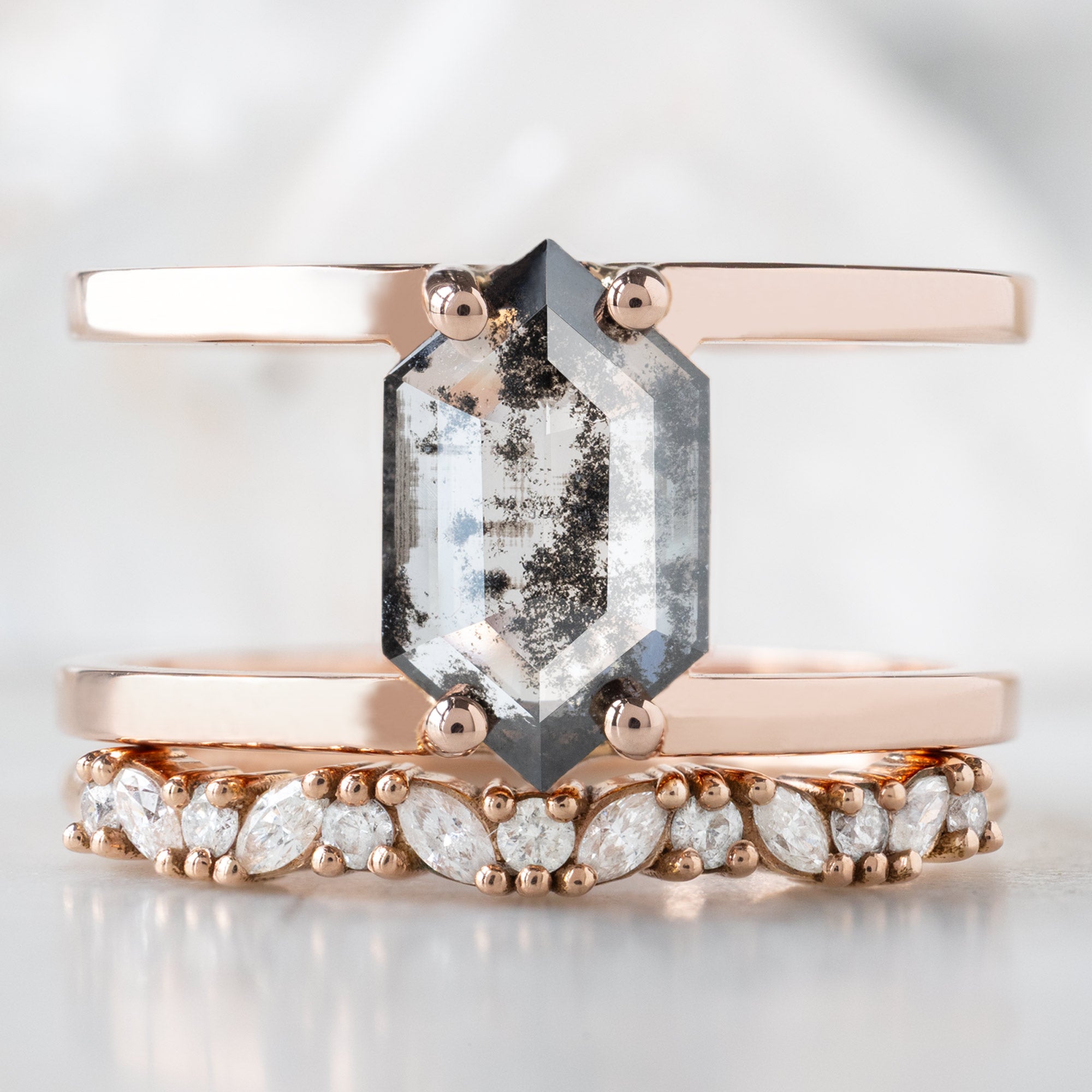 The Poppy Ring with a 1.21ct Lab Grown Salt and Pepper Hexagon in 14K Rose Gold Stacked with the Confetti Marquise Diamond Wedding Band