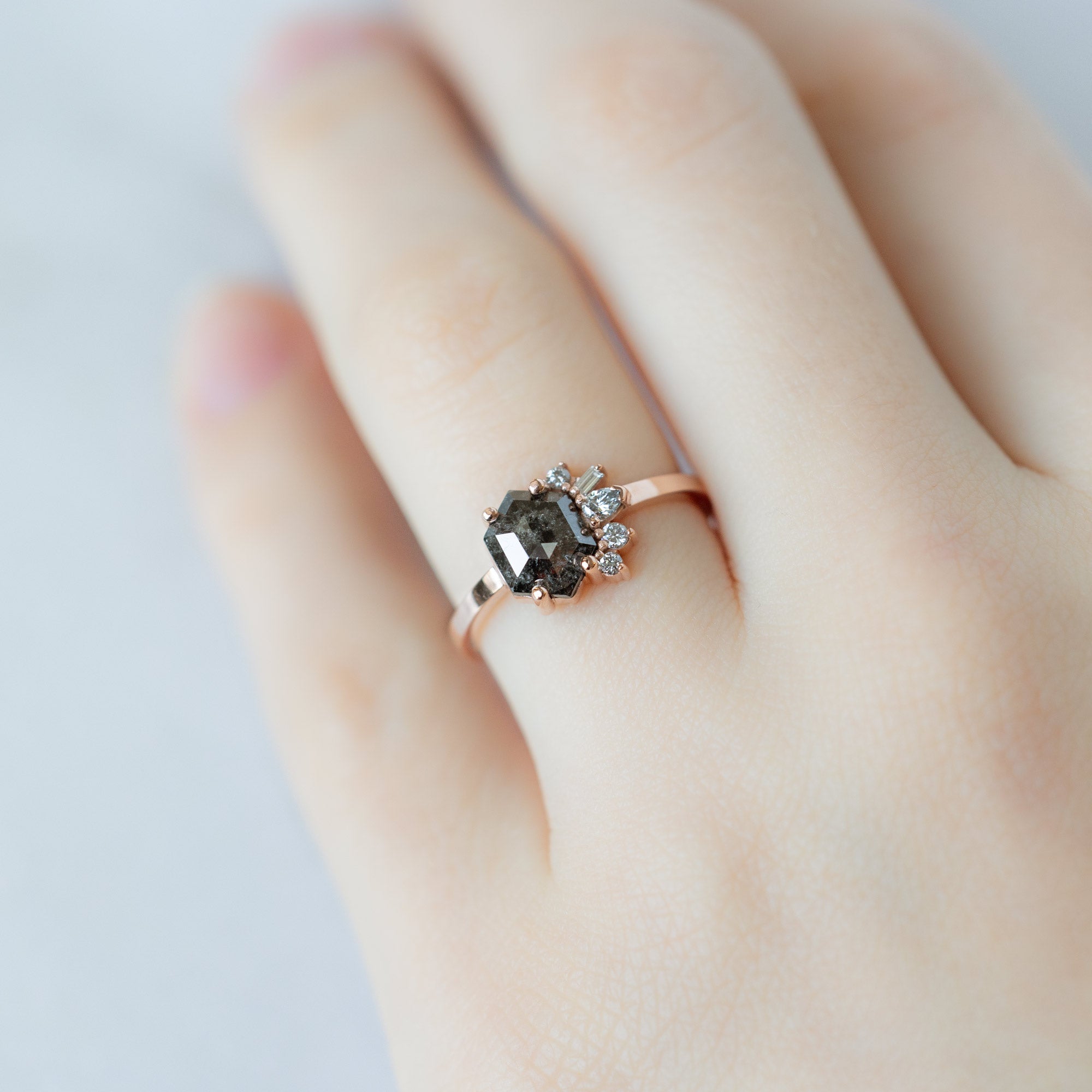 The Cluster Ring with a 1.07ct Hexagon Black Diamond in 14K Rose Gold on Model