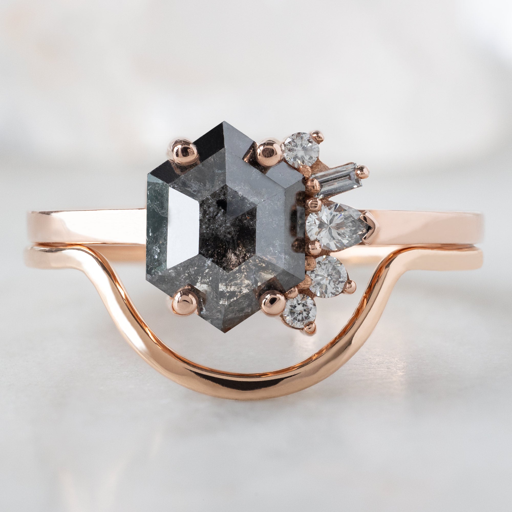 The Cluster Ring with a 1.07ct Hexagon Black Diamond in 14K Rose Gold Stacked with the Gold Arc Stacking Band