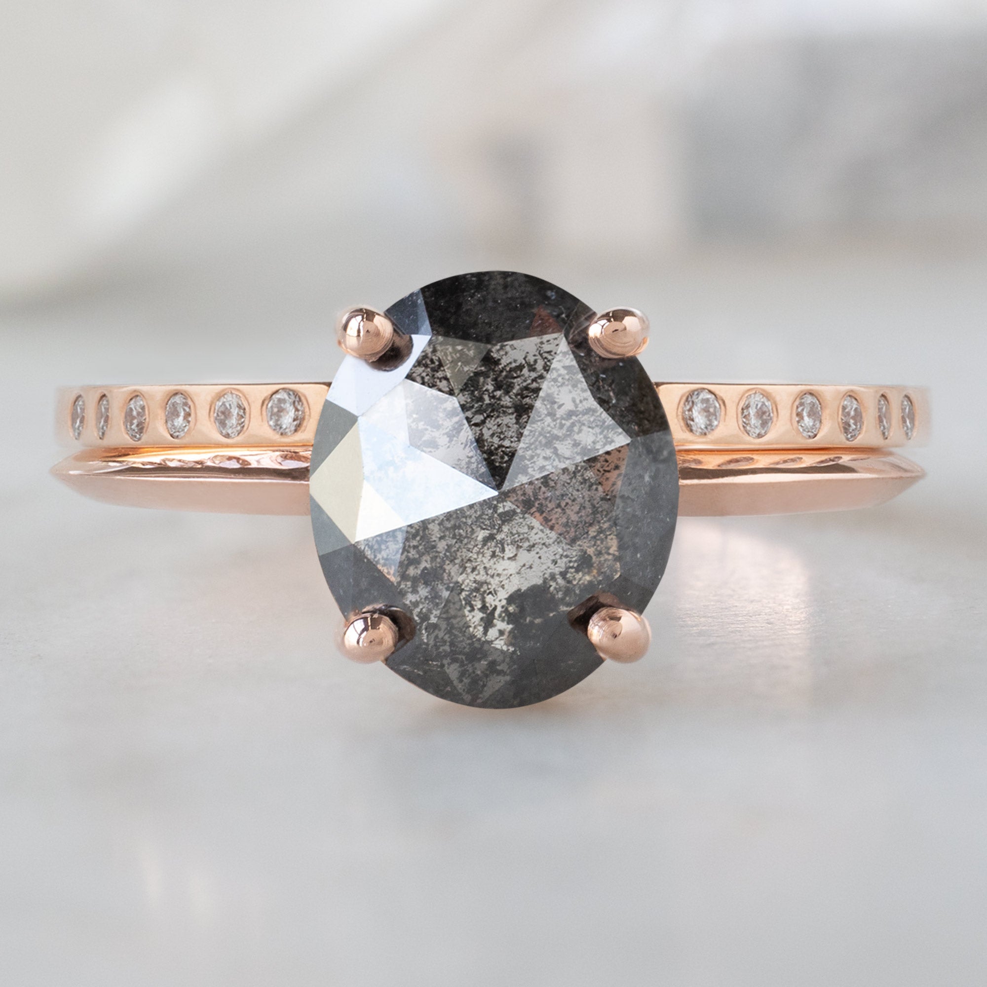 The Bryn Ring with a 1.53ct Oval Salt and Pepper Diamond in 14K Rose Gold Stacked with Open Cuff Flush Set Diamond Stacking Band