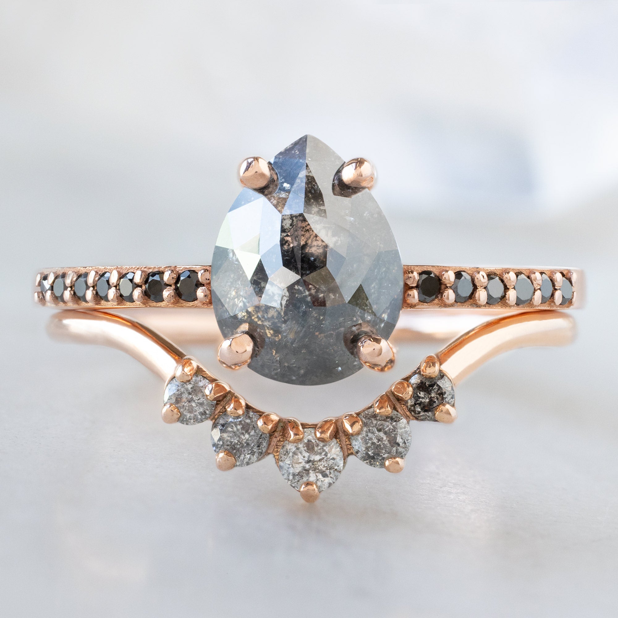 buy:the-willow-ring-1-59ct-pear-black-diamond-in-14k-rose-gold,round-salt-and-pepper-diamond-sunburst-stacking-band-14k-or-18k-yellow-gold
