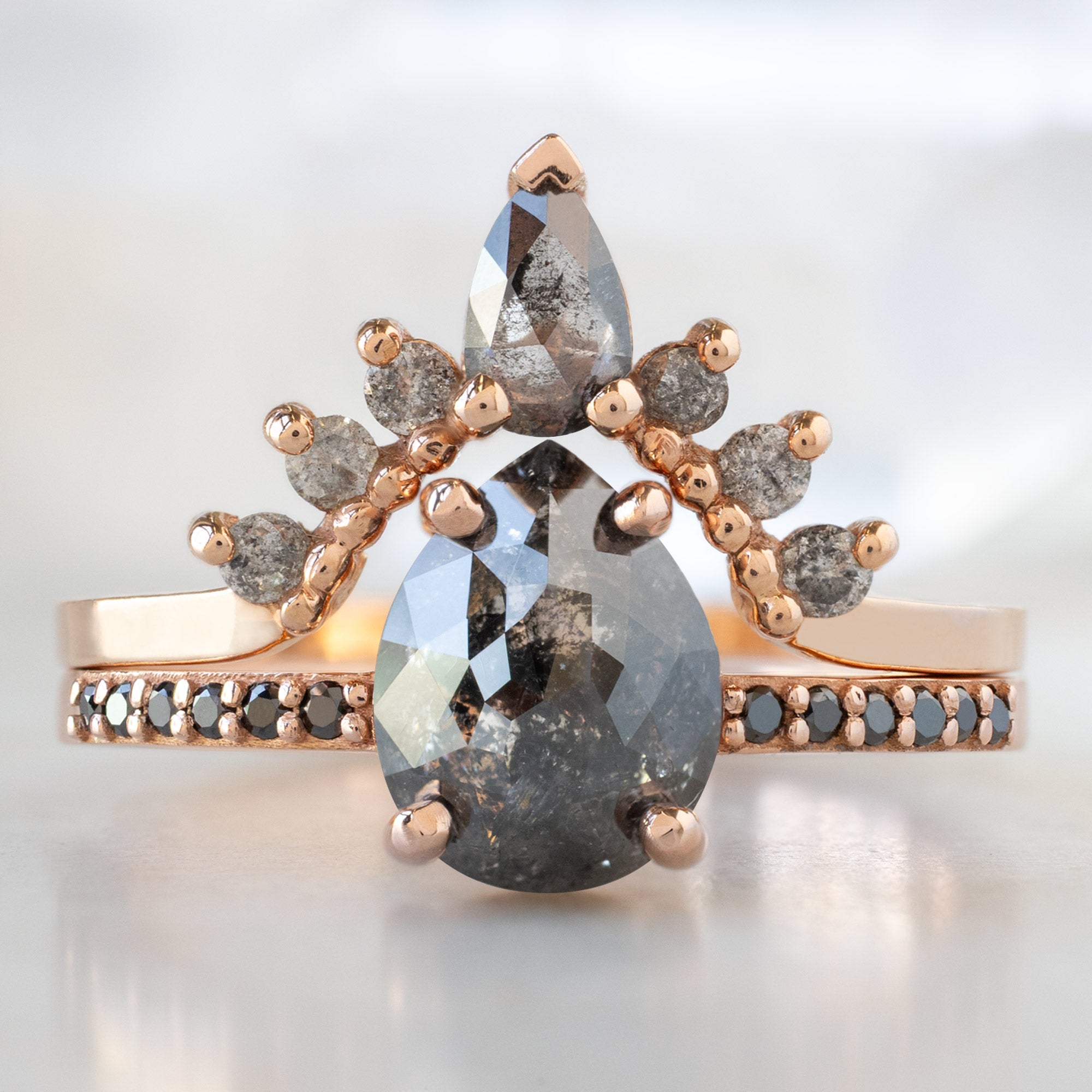 The Willow Ring with a 1.59ct Pear Black Diamond in 14K Rose Gold  Stacked with the Salt and Pepper Diamond Sunburst Stacking Band