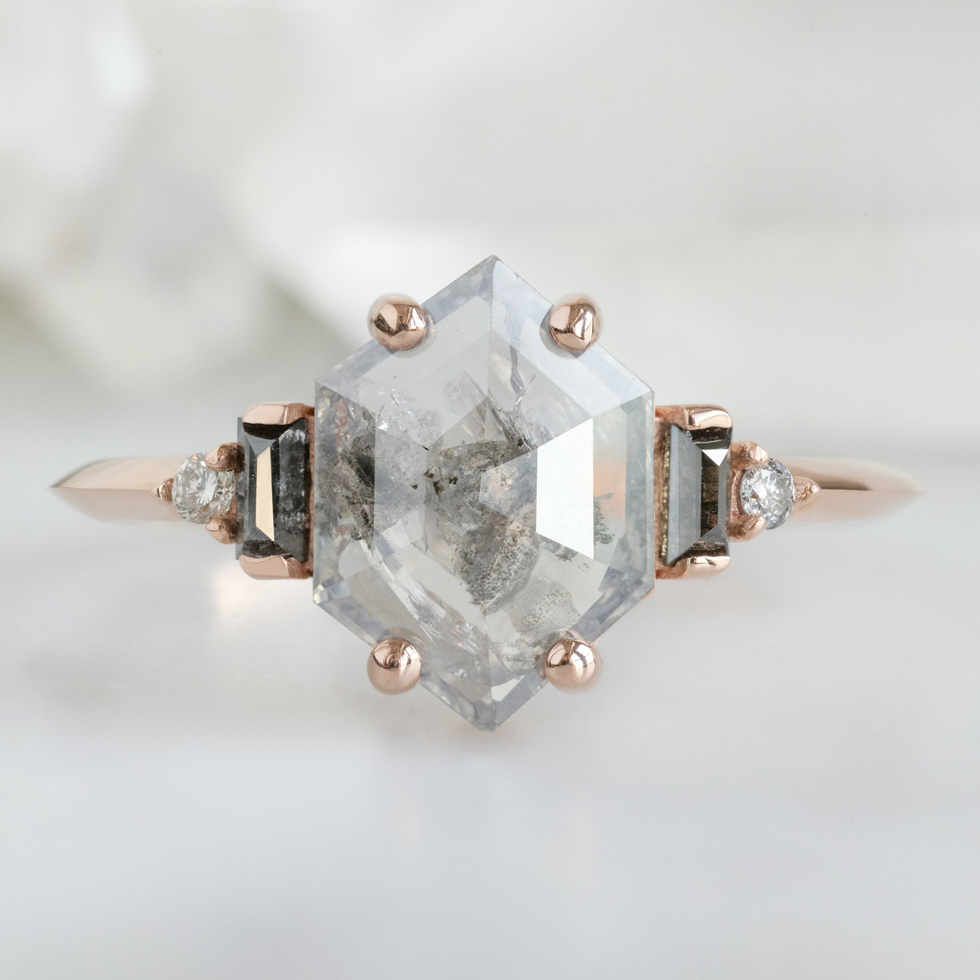 The Primrose Ring with a 1.21ct Hexagon Salt and Pepper Diamond in 14K Rose Gold on White Marble