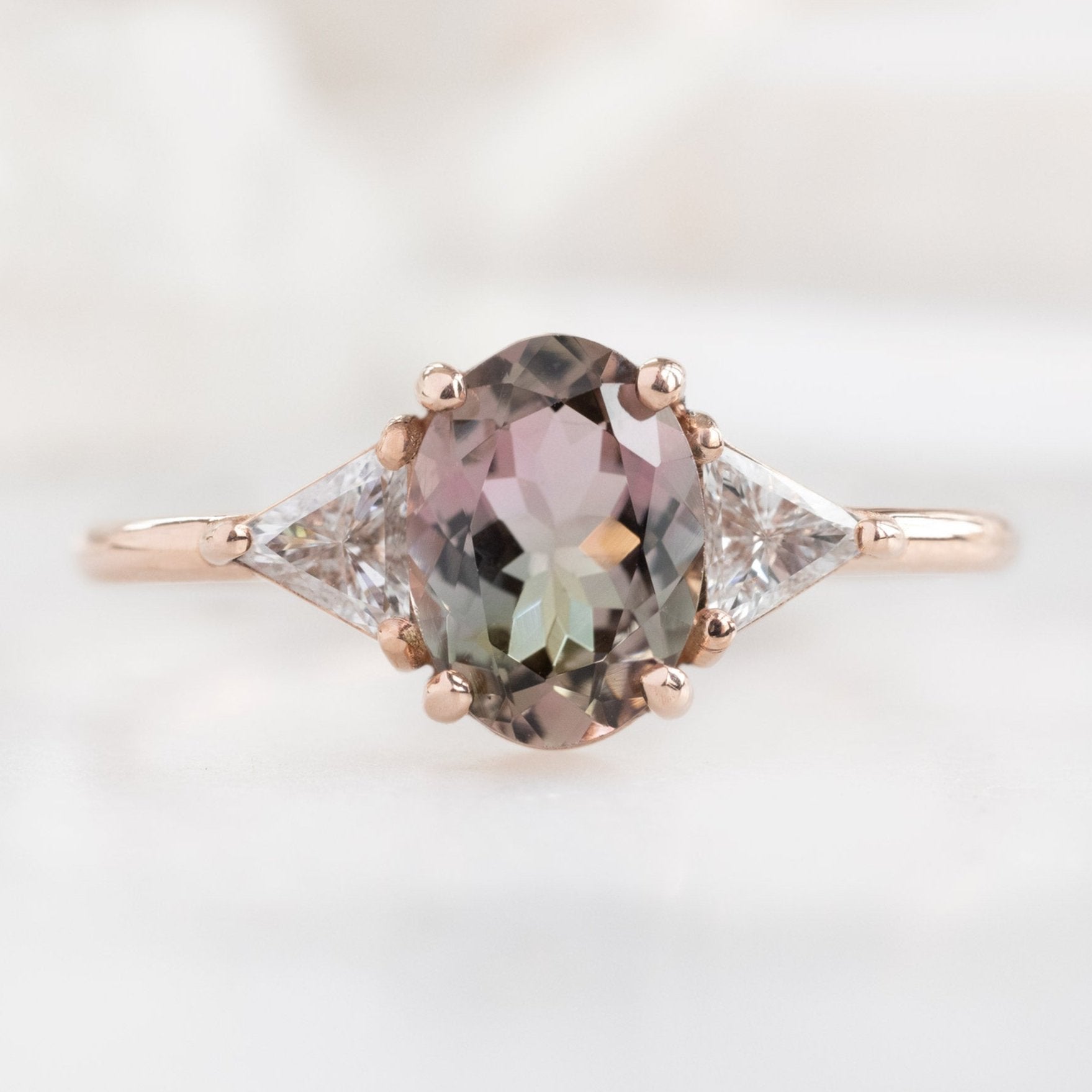 The Jade Ring with an Oval Bicolor Tourmaline in 14K Rose Gold on White Marble