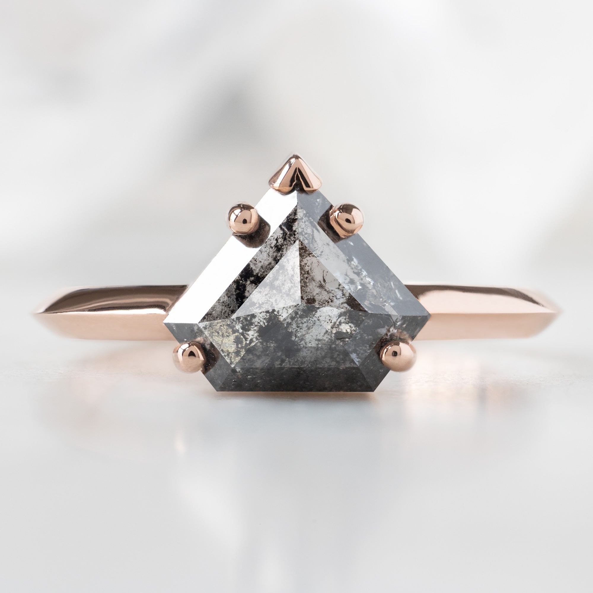 The Sage Ring with a 1.18ct Shield Salt and Pepper Diamond in 14K Rose Gold on White Marble
