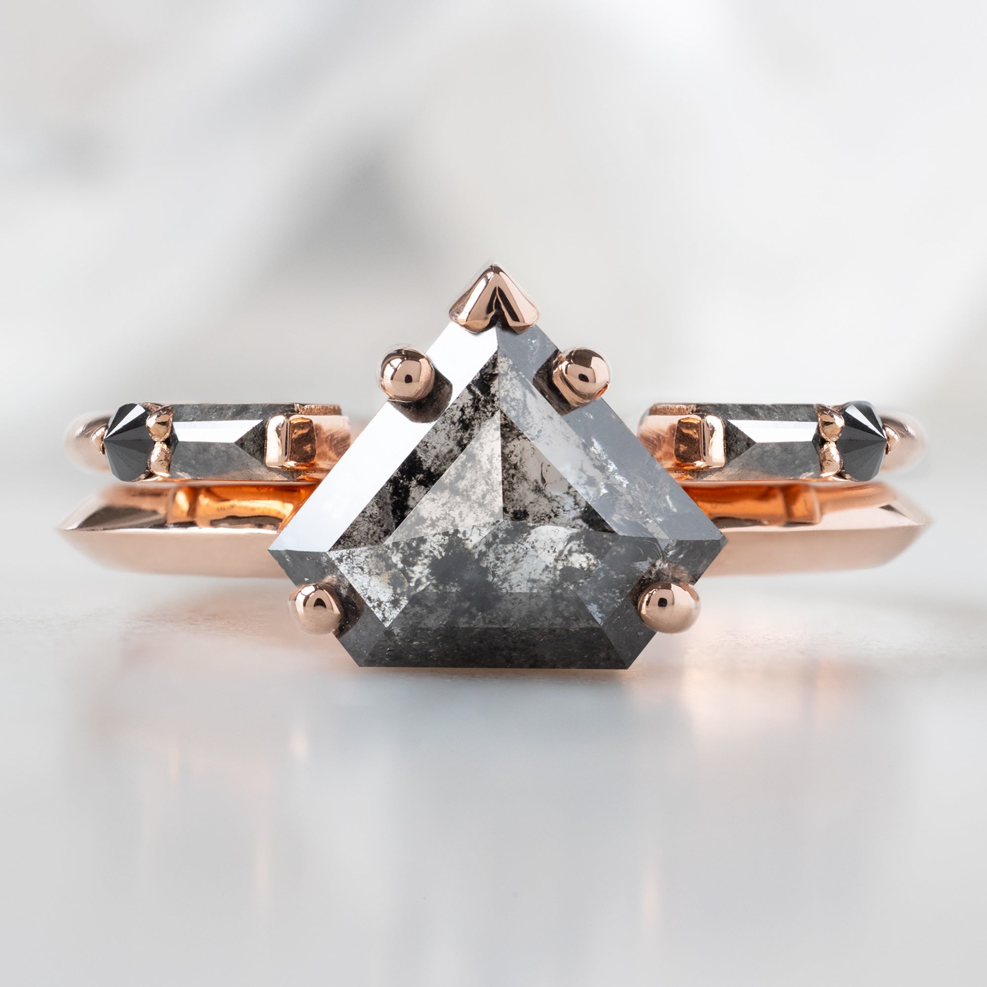 The Sage Ring with a 1.18ct Shield Salt and Pepper Diamond in 14K Rose Gold Stacked with the Luxe Open Cuff Black Diamond Baguette Stacking Band on White Background