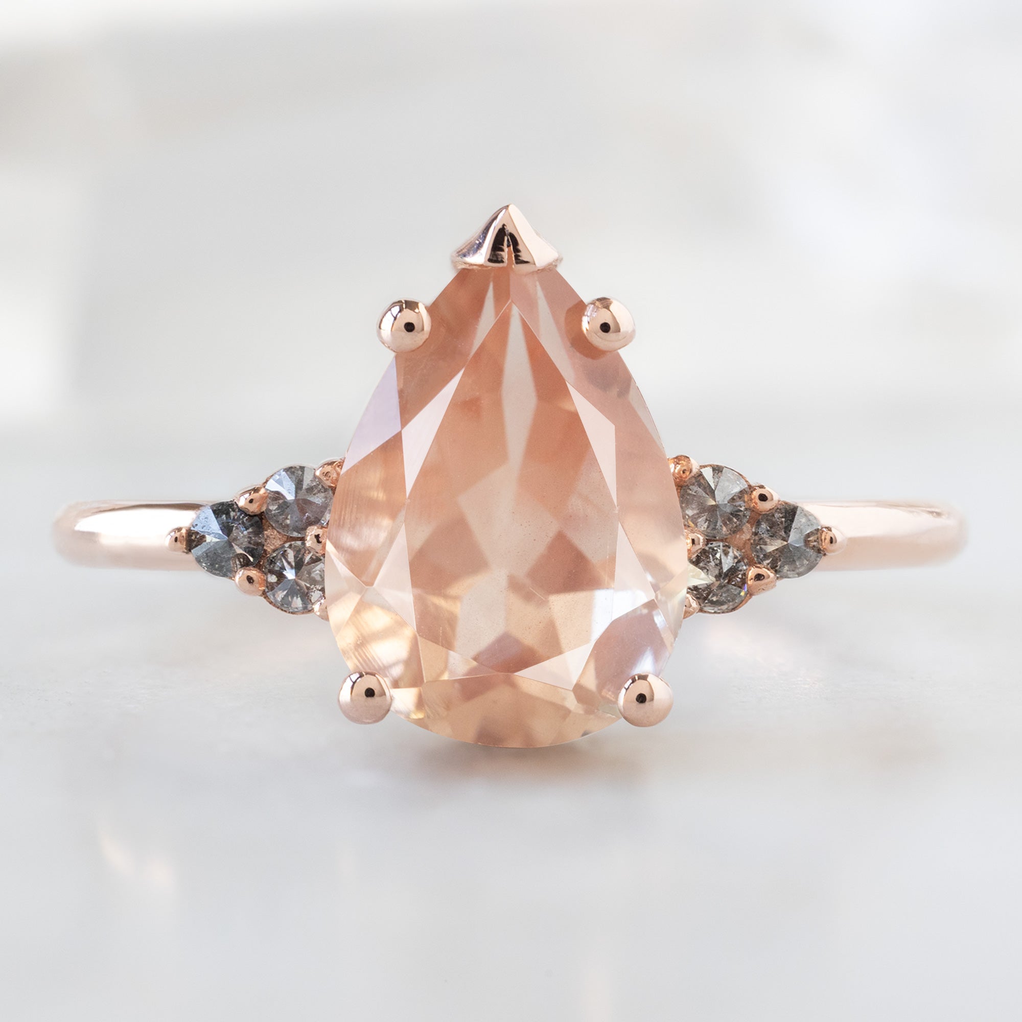 The Ivy Ring with a 1.89ct Pear Shaped Sunstone in 14K Rose Gold on White Marble